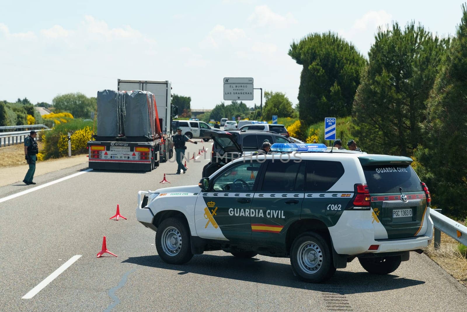 Sahagun, Spain - June 5, 2023: Civilian police are restricting traffic and blocking traffic with police vehicles.