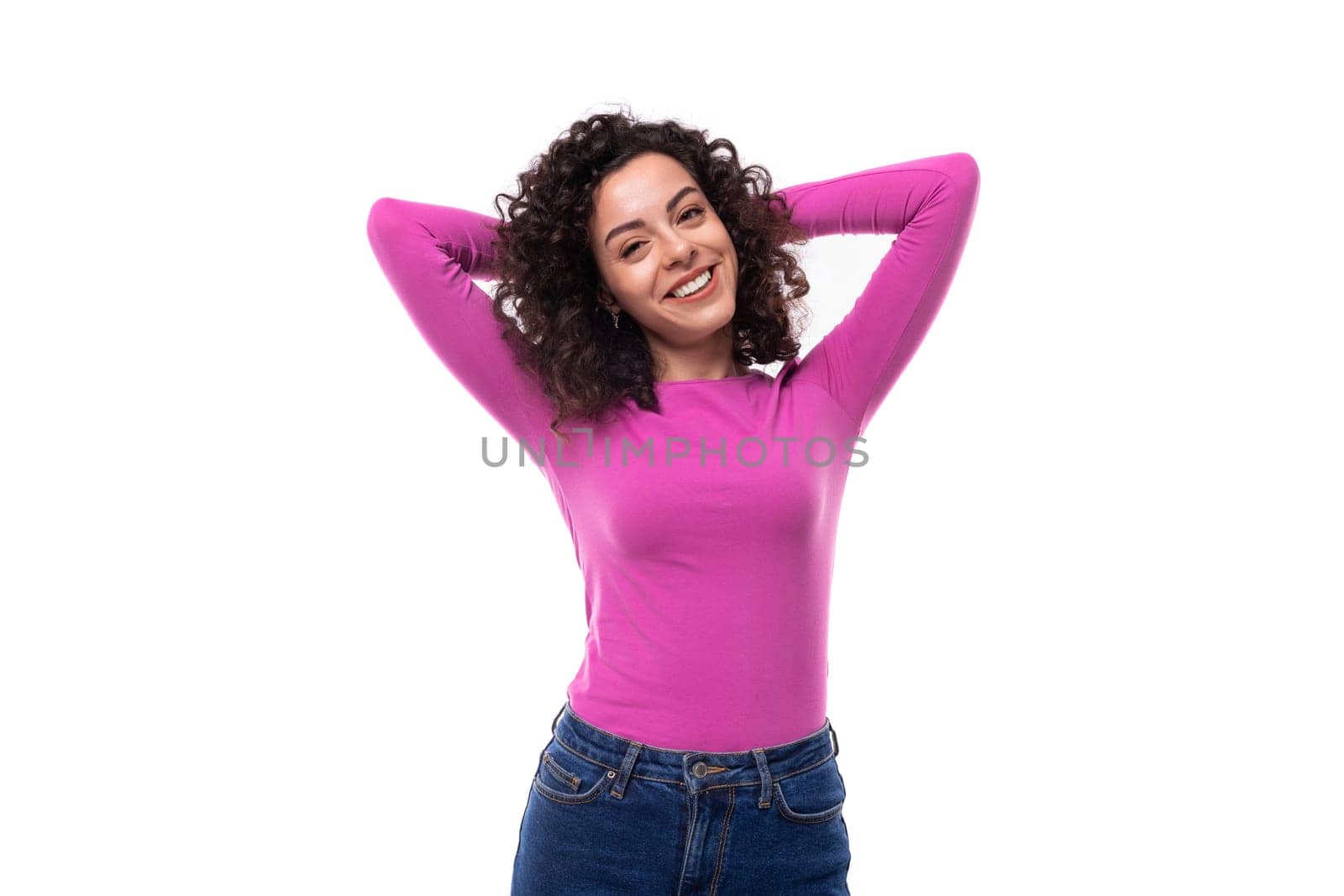 young fashionista curly brunette lady dressed in a fresh lilac color turtleneck on a white background.