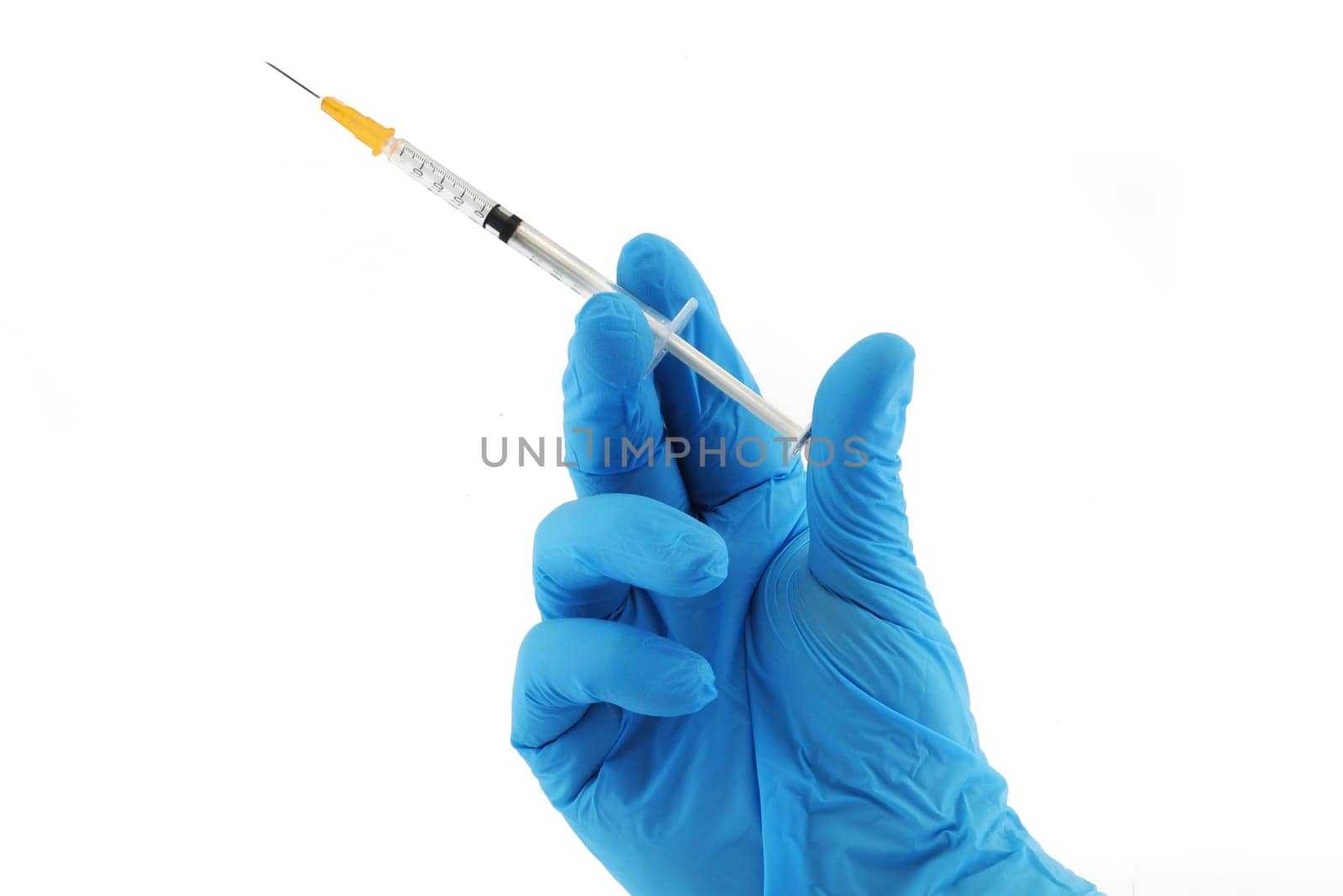 A vaccination syringe and hand in blue surgical glove
