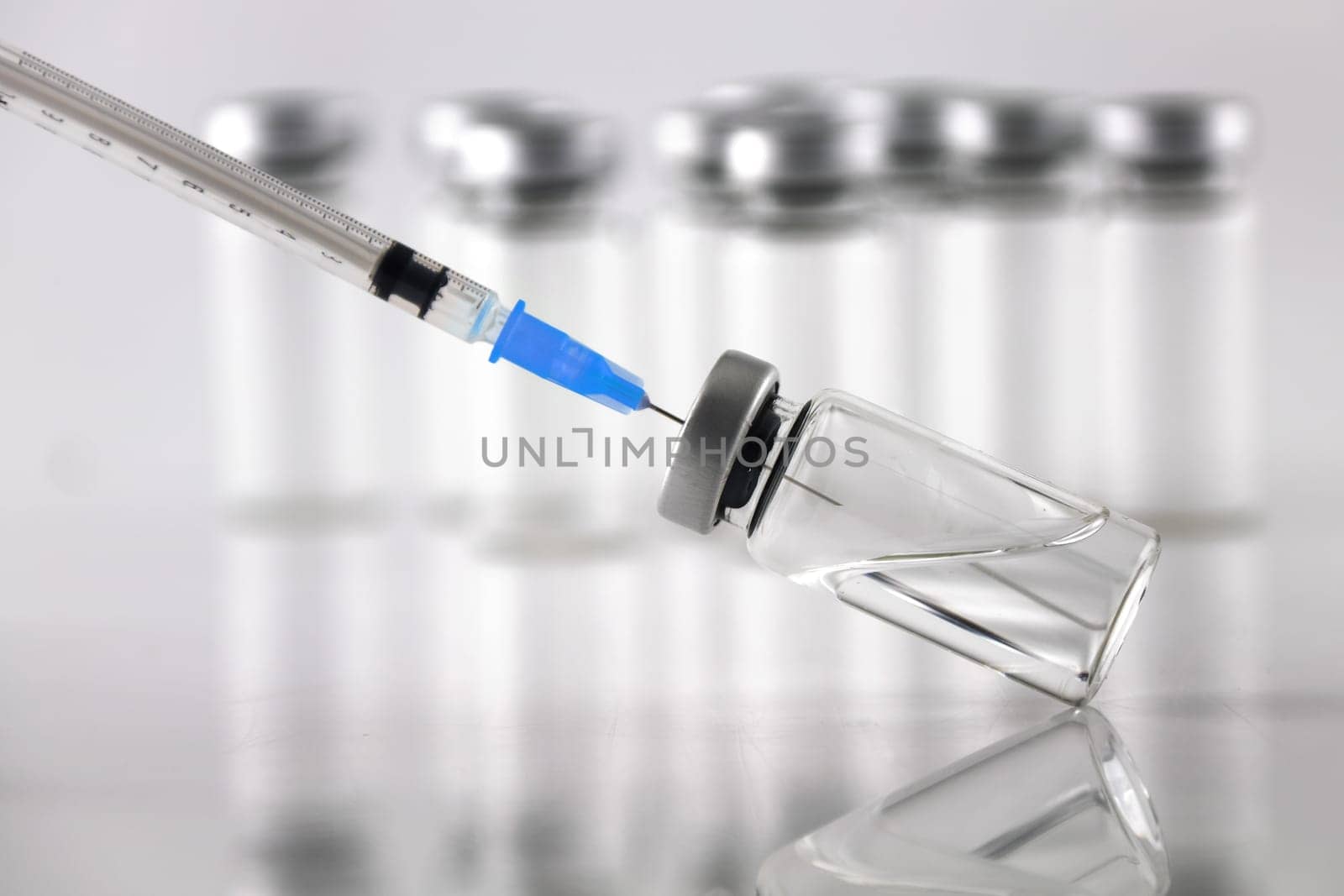 A syringe and ampule bottles for vaccination on white background