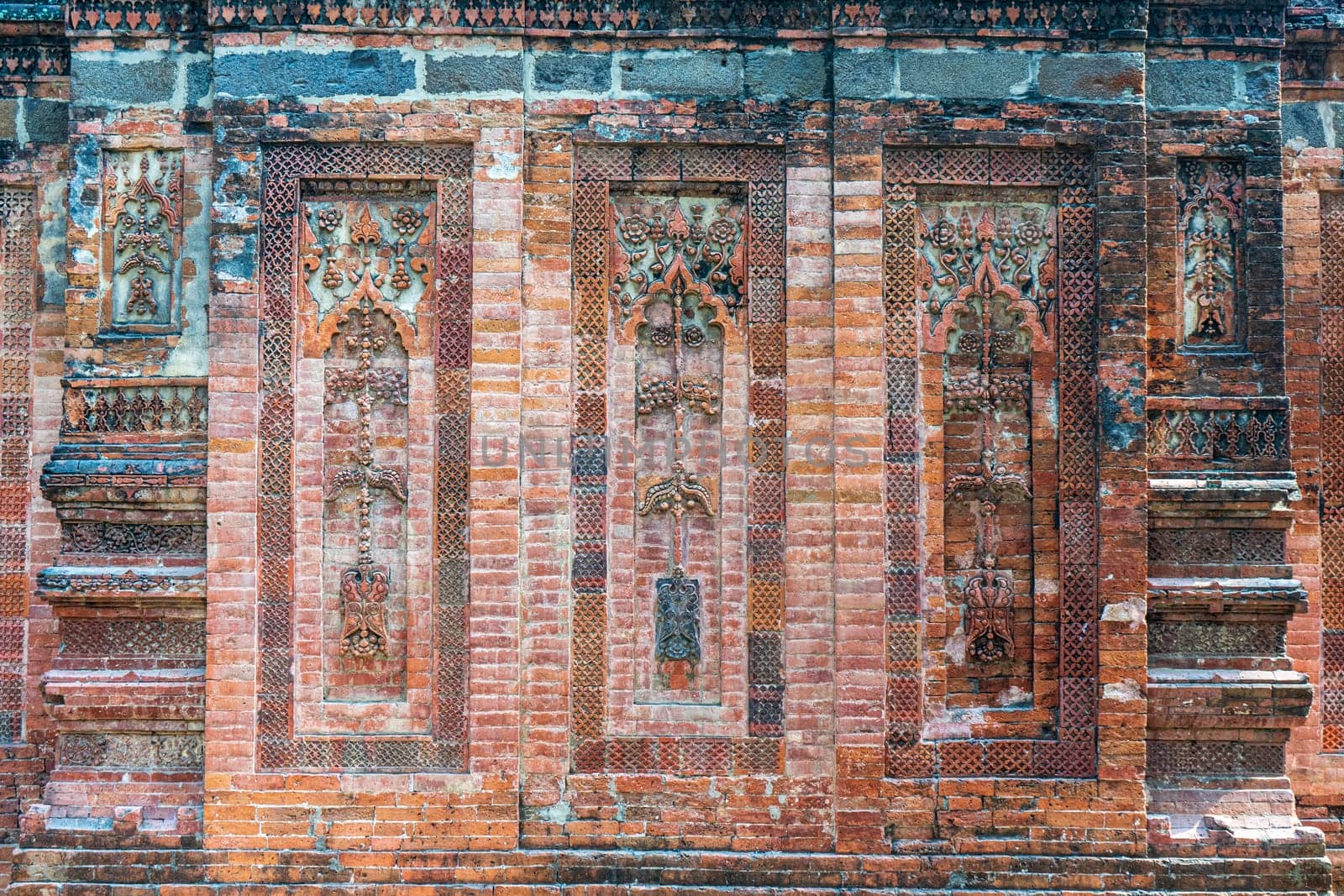 Terracotta patterns ancient stone carving, pattern on stone wall of Bagha Shahi Mosque