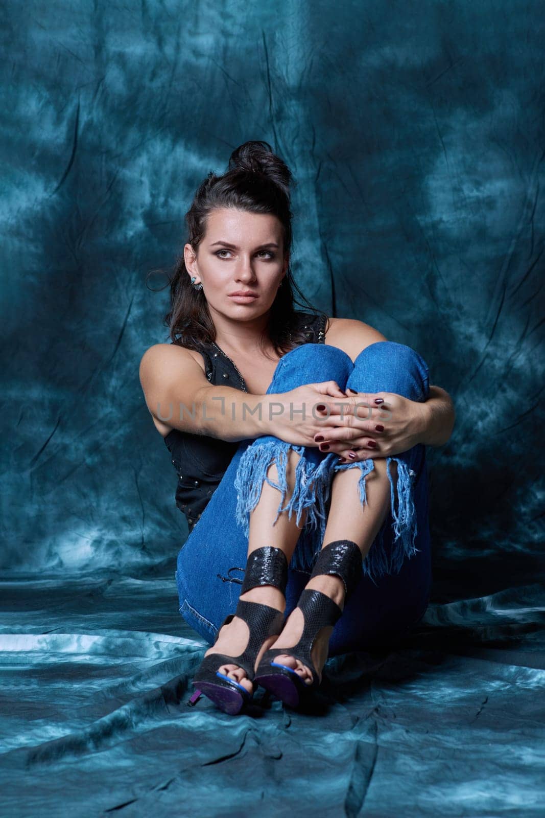 Young trendy woman posing in studio in denim style by VH-studio