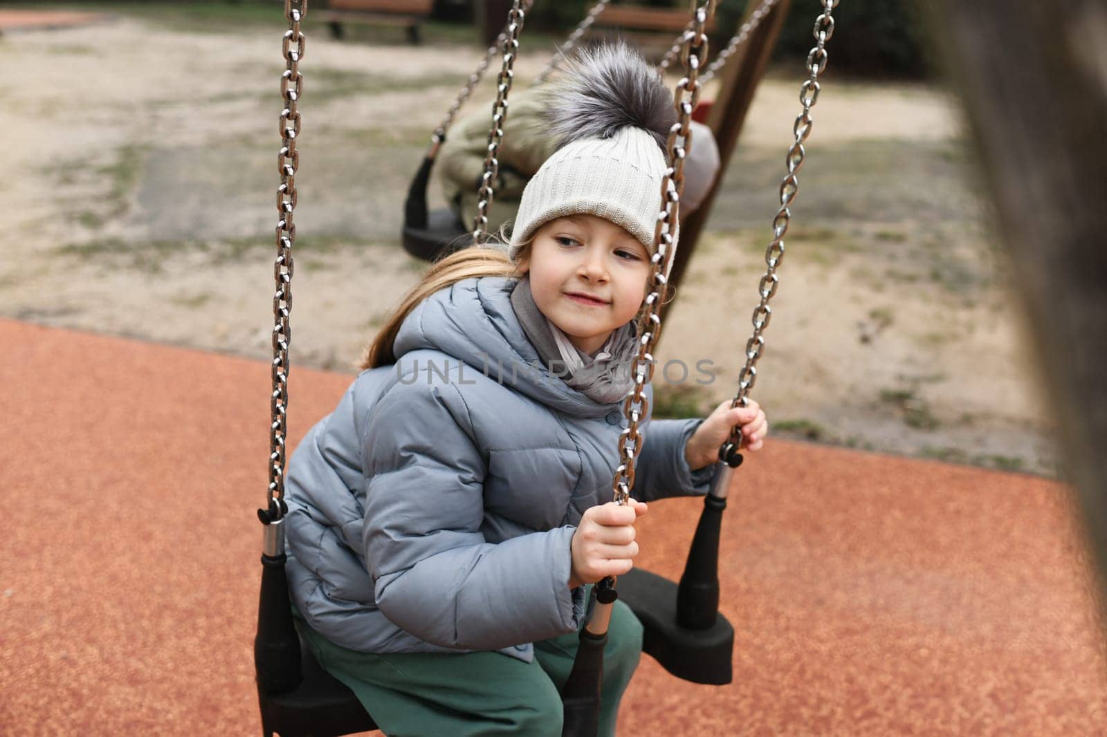 Girl six years old riding on a swing by Godi