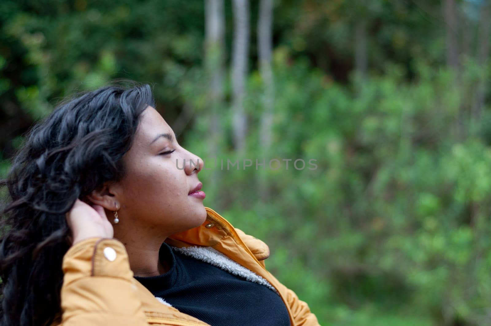 copy space of beautiful latina woman resting after a day of hiking in a forest in ecuador. day of tourism. High quality photo