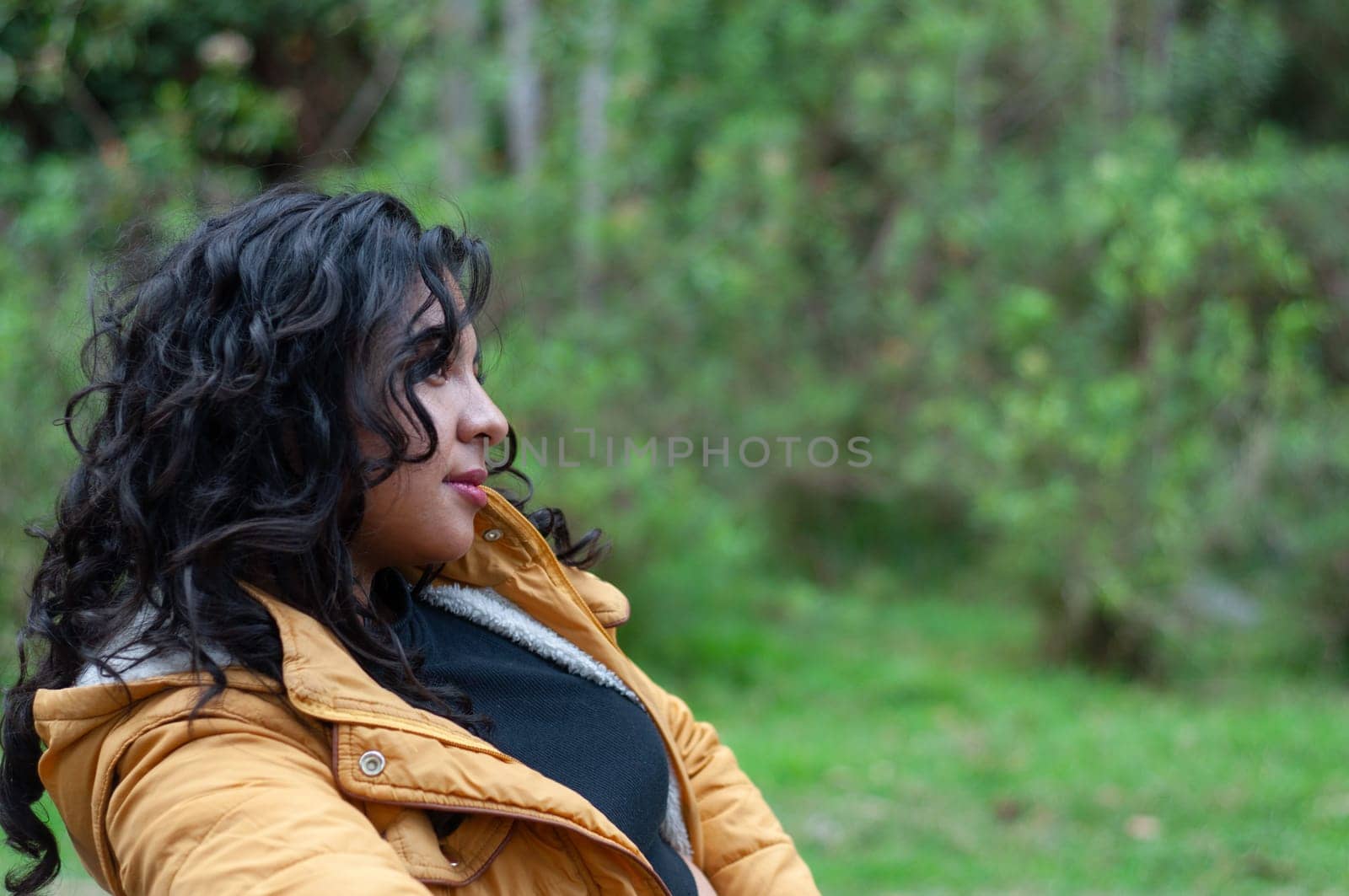 copyspace of colombian girl with a yellow jacket resting in a forest with lots of vegetation after doing rural tourism. day of rural tourism. High quality photo