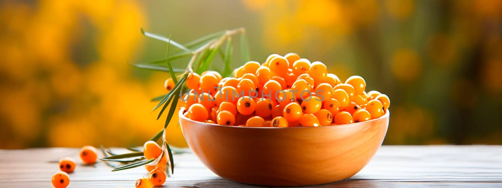 Sea buckthorn in a bowl against the backdrop of the garden. Selective focus. Food.