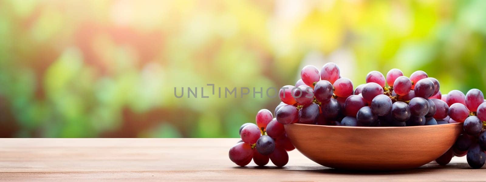 Grapes in a bowl against the backdrop of the garden. Selective focus. by yanadjana