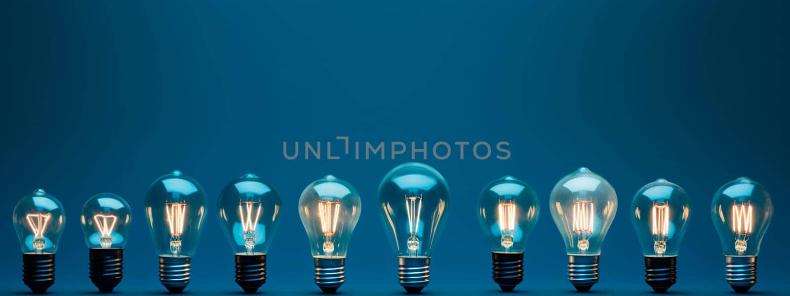 Many light bulbs on a blue background. Selective focus. Light.