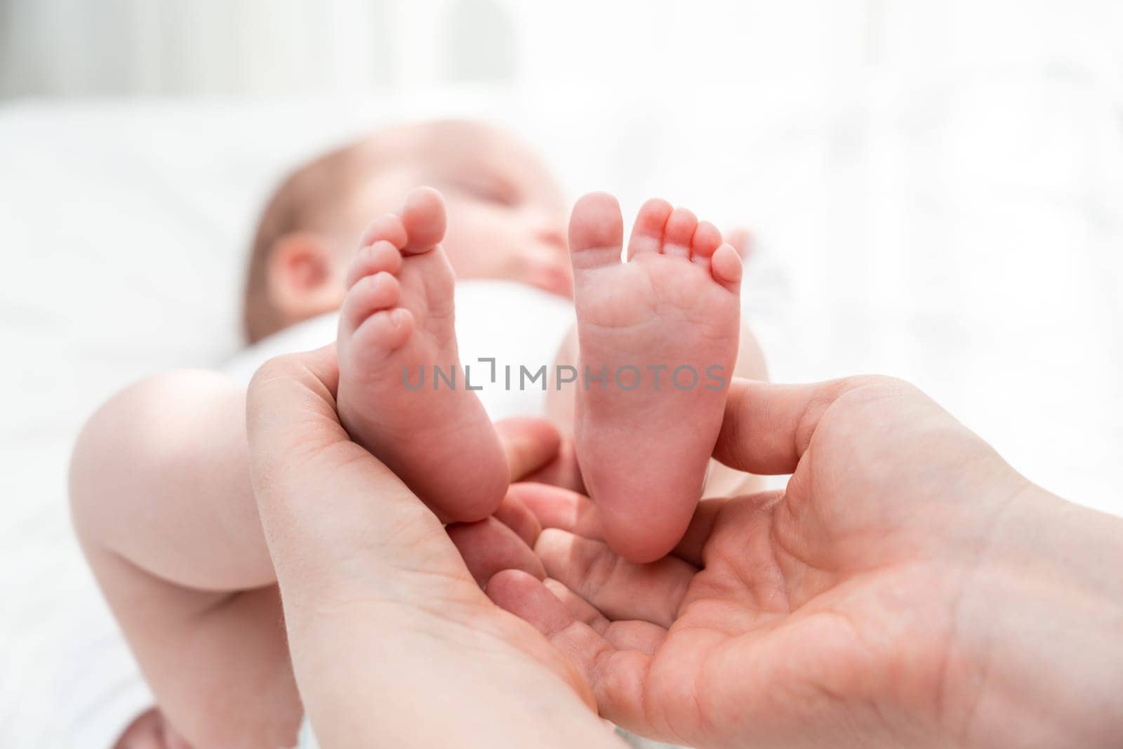 Newborn's tiny feet held with care, Concept of a mother's protective embrace by Mariakray