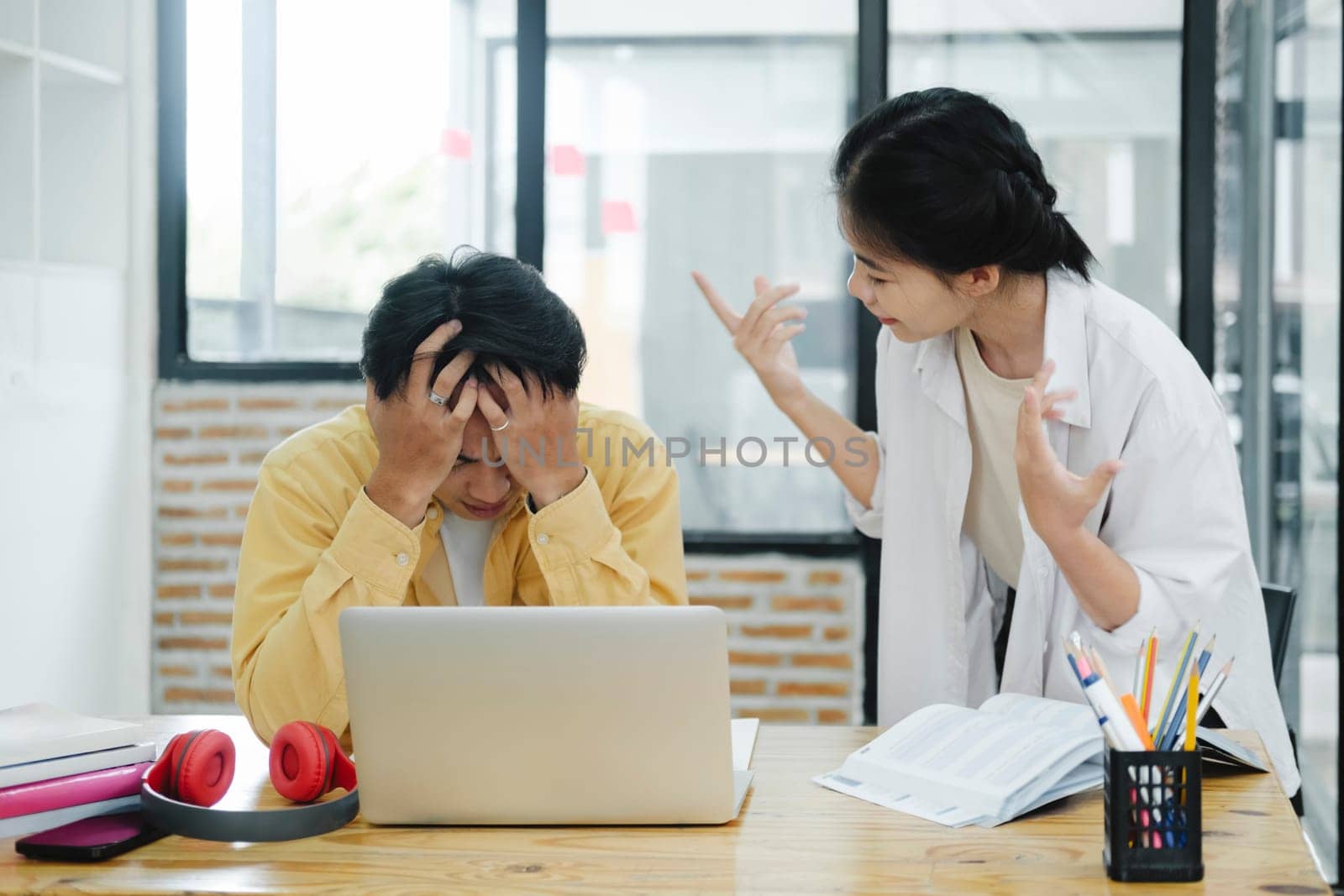 Young female explain idea to worker business conflict quarrel misunderstanding with partners. Two colleagues arguing at work. Angry young woman arguing with man about paperwork failure at workplace, executives having conflict over responsibility for bad work results, partners disputing about contract during meeting..