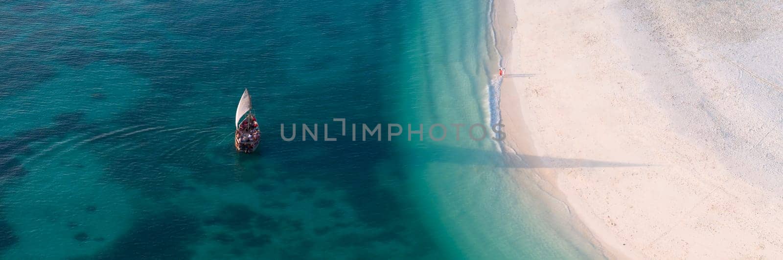 high angle view of tourist boat in the green ocean and white sandy beach by Robertobinetti70