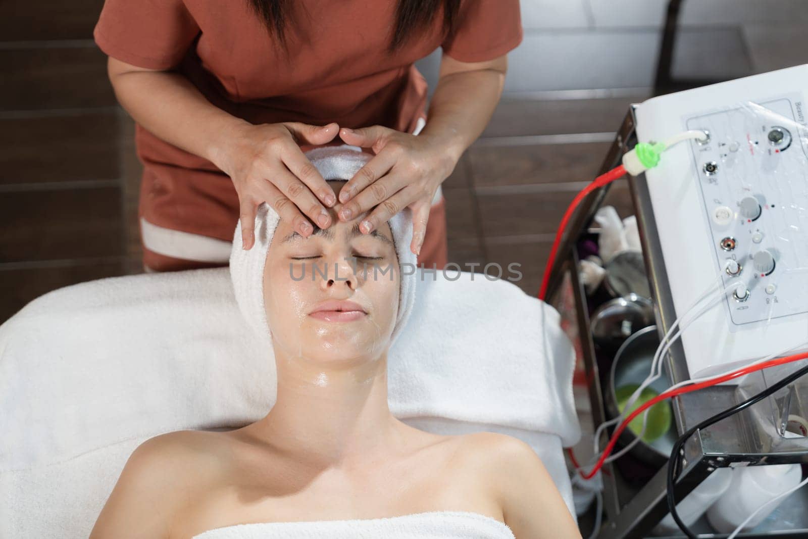 Beautiful women having facial massage surrounded by medical machine.Tranquility. by biancoblue