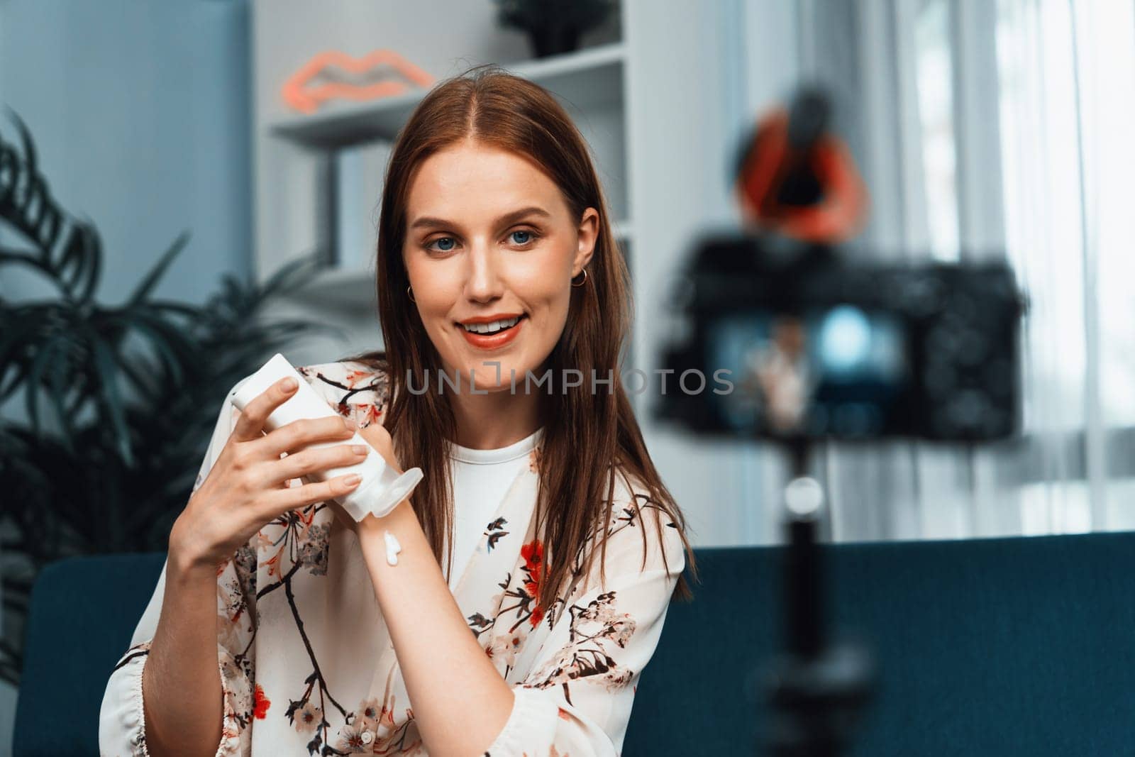 Woman influencer shoot live streaming vlog video review makeup utmost social media or blog. Happy young girl with cosmetics studio lighting for marketing recording session broadcasting online.