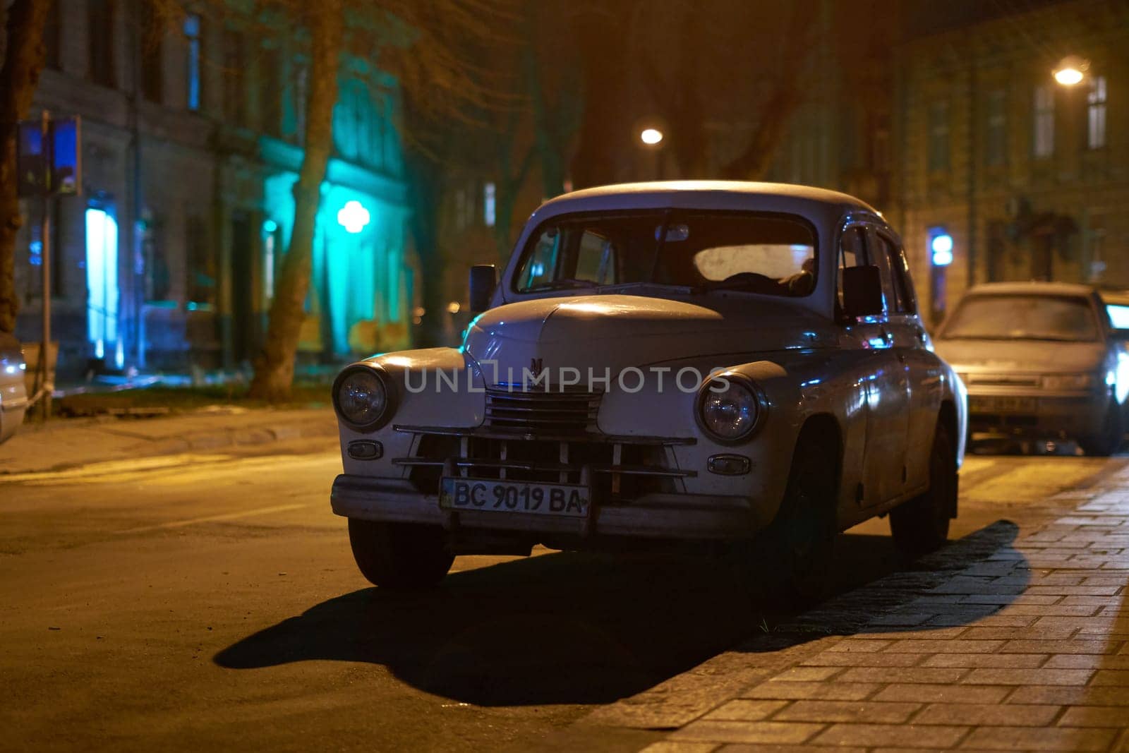 Lviv, Ukraine - Dec 01, 2017: Old retro car GAZ M20 Pobeda released circa 1950 in USSR parked on the night city street