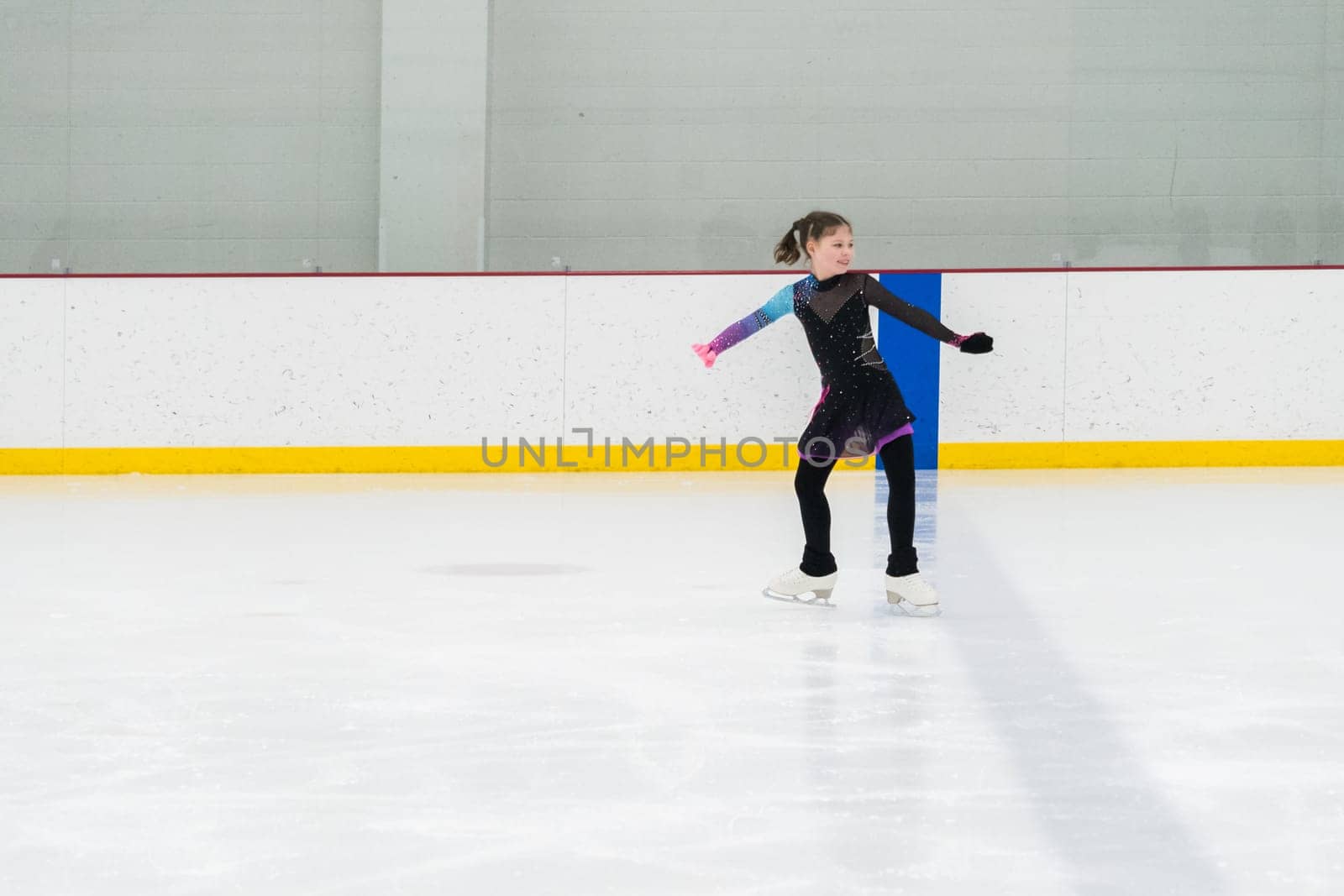 Figure skating practice at an indoor skating rink by arinahabich