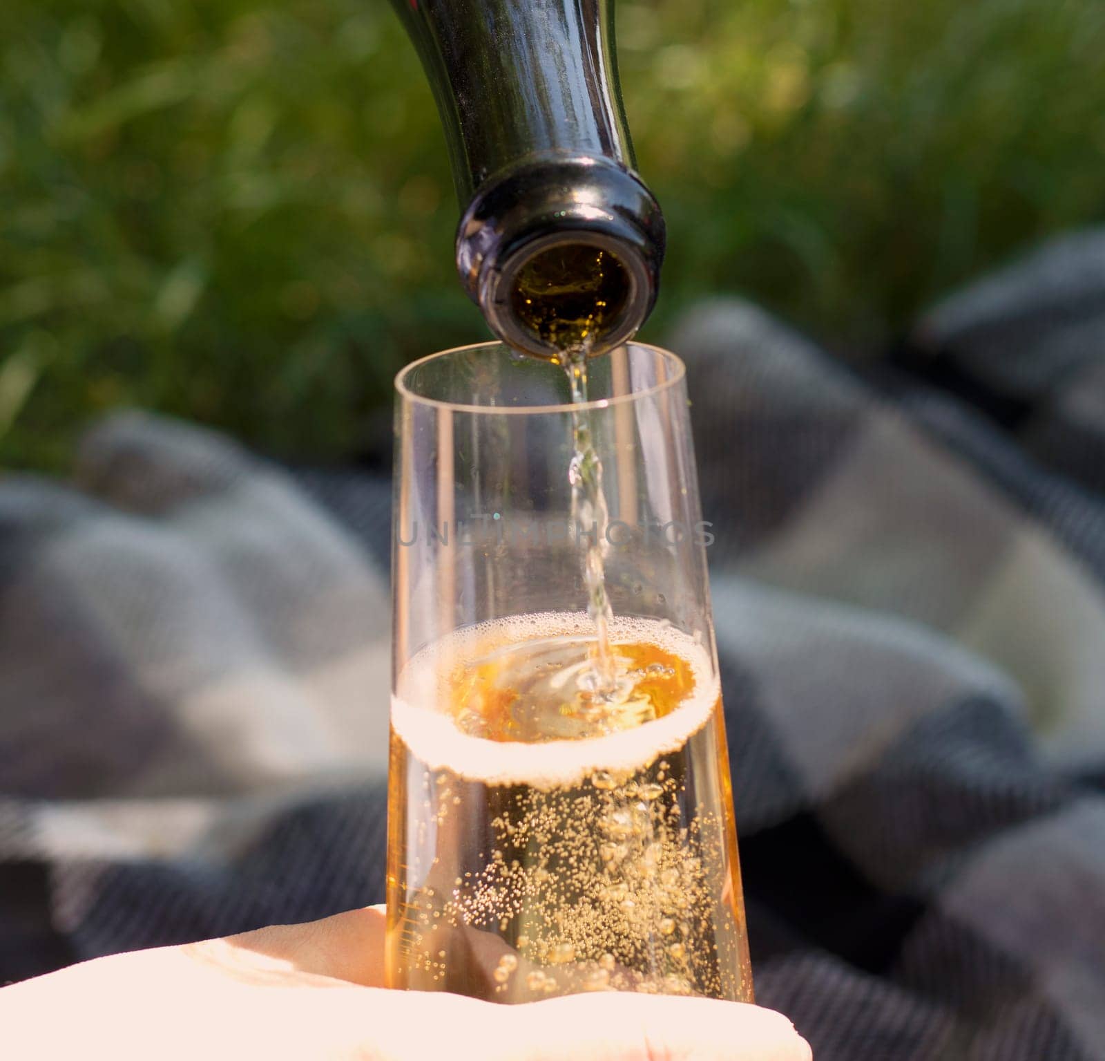 Wine. Glass of wine. Hands serving bottles of wine in transparent glasses . Toast. Celebration day. Photography. Hand pouring white wine in glass. Close up view.