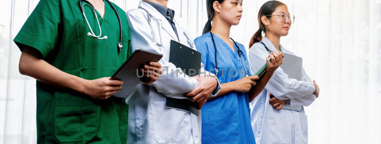 Confident and professional team of medical staff stand in line together. Rigid by biancoblue