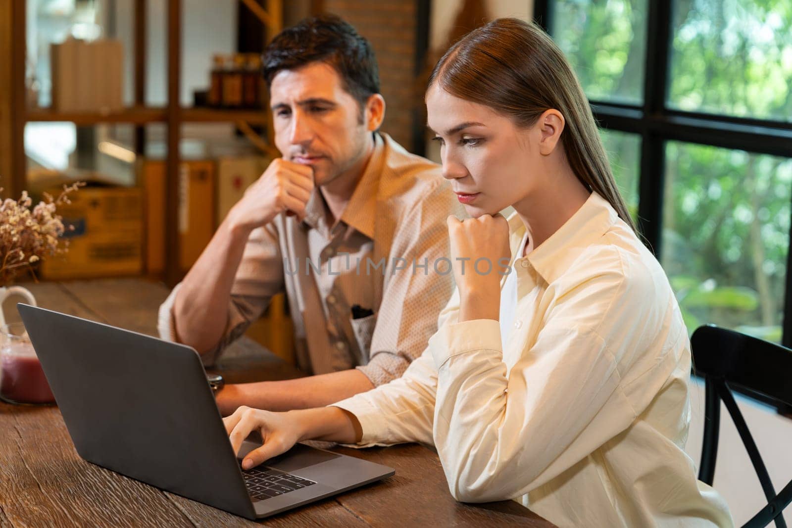 Young couple working remotely on laptop in cafe look tired. Expedient by biancoblue