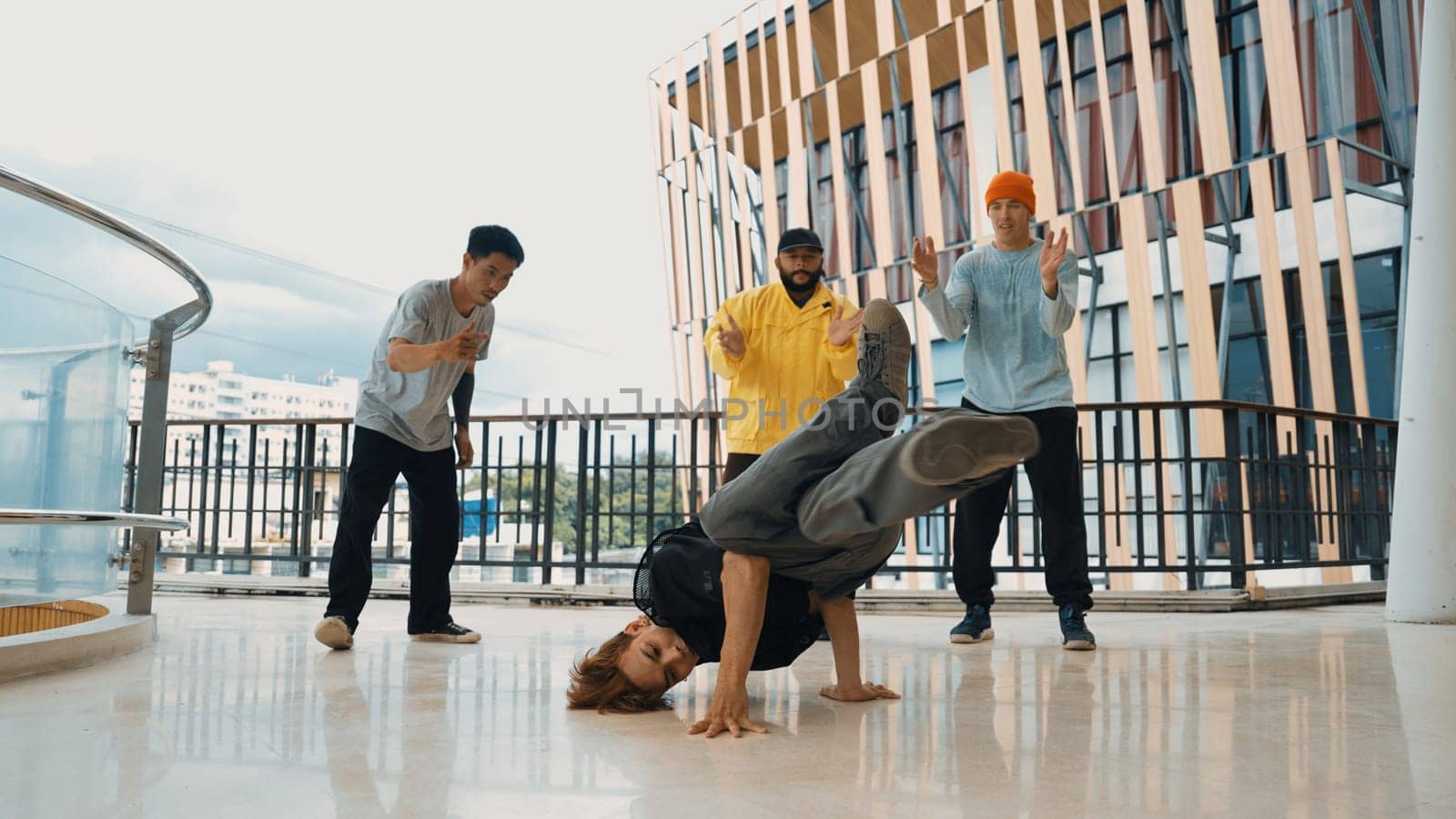 Hip hop team dance break dance while multicultural friend surrounded and clapping hands to cheer or encourage his friend to dance. Active and energetic street dance. Outdoor sport 2024. Endeavor.