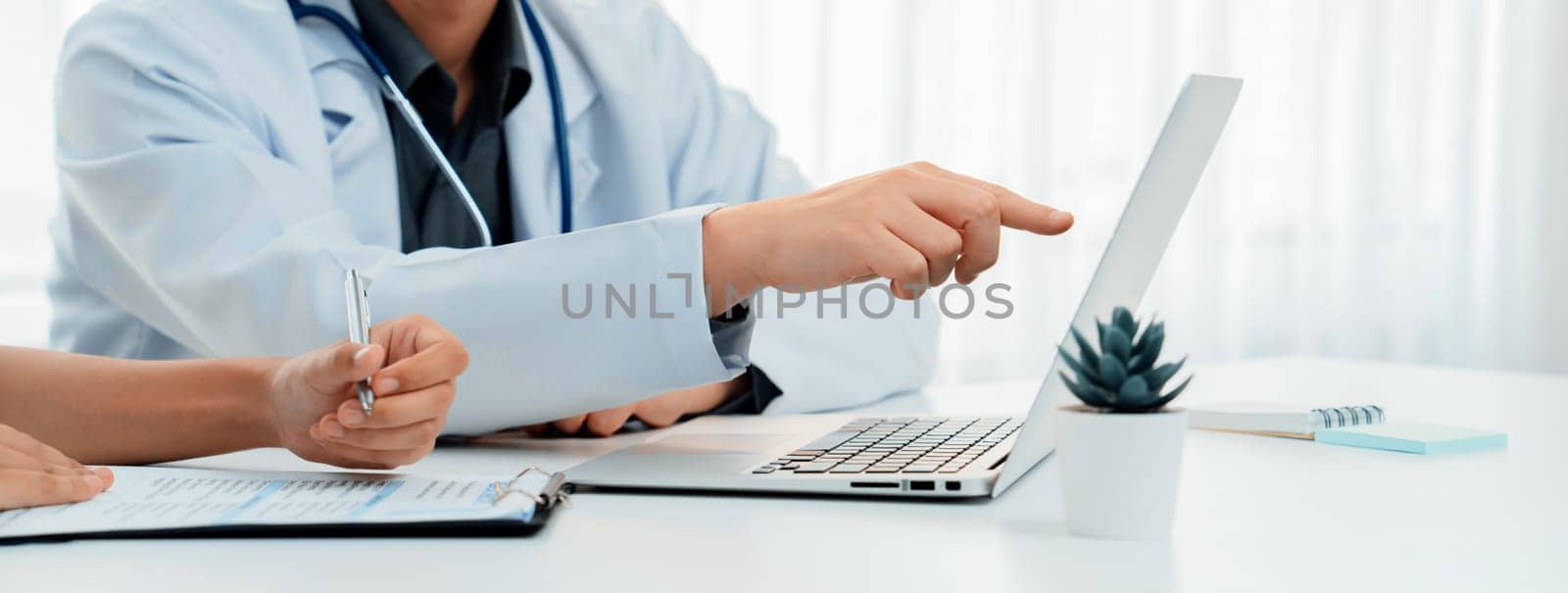 Professional various team of medical working and planning medical treatment at hospital table together. Teamwork lead to successful illness and sickness treatment. Panorama Rigid