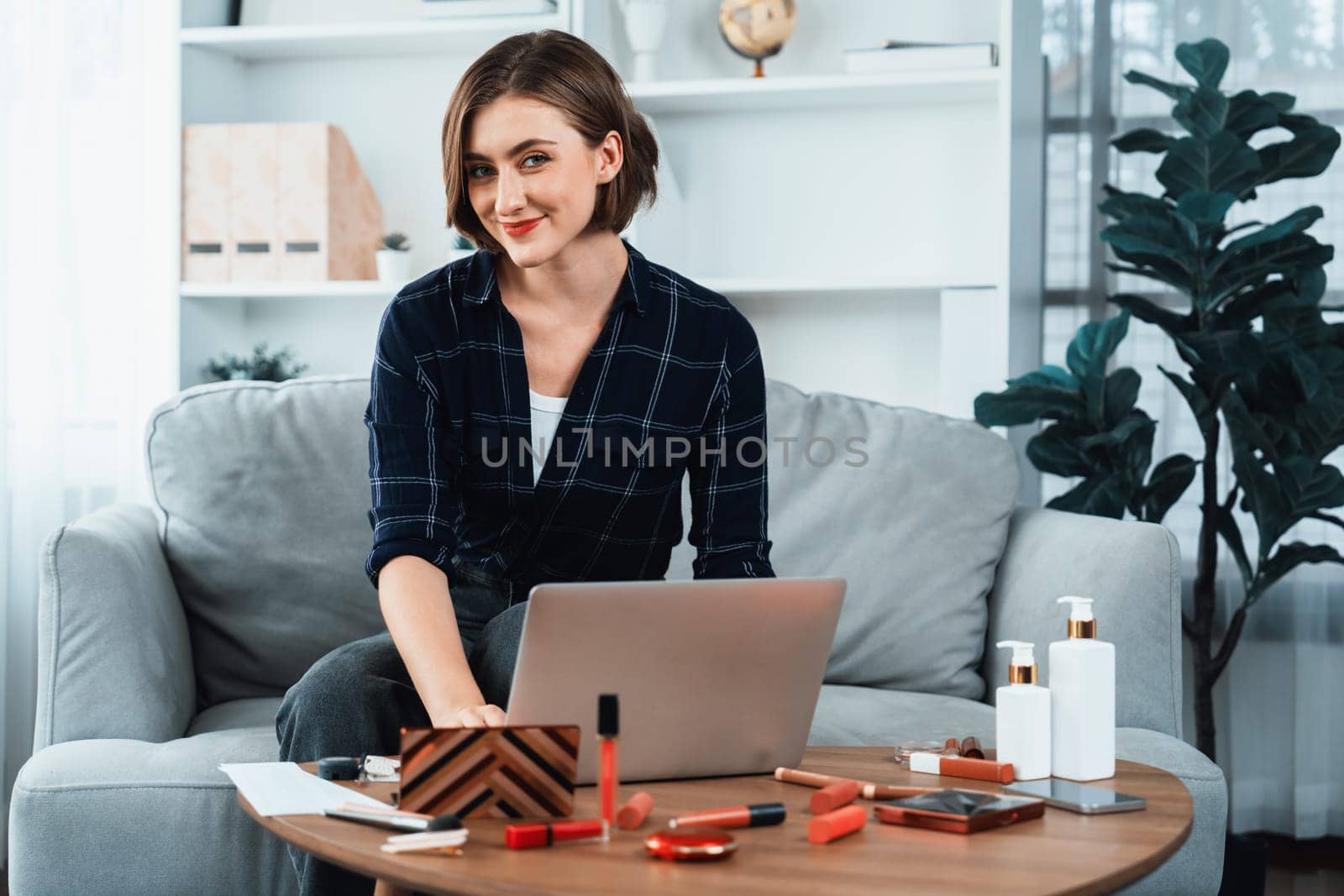 Young happy woman buy product by online shopping at home while ordering items from the internet with credit card online payment system protected by utmost cyber security from online store platform