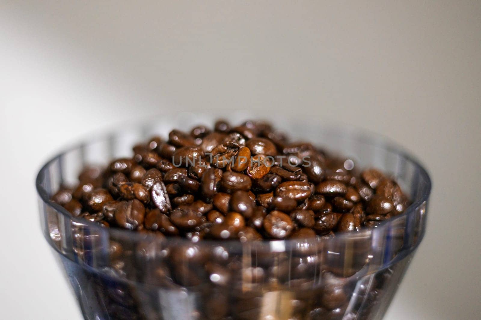 Coffee beans in a crystal jar on a white background. 