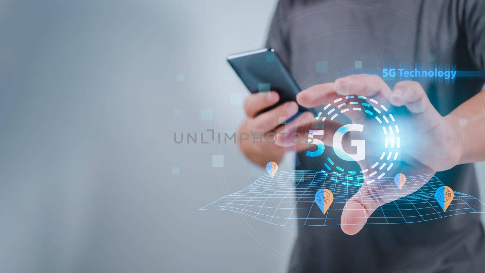 Close-up of human hand holding smartphone and pointing at 5G hologram, 5G wireless network system, 5G network concept, High speed mobile internet, New era connection network