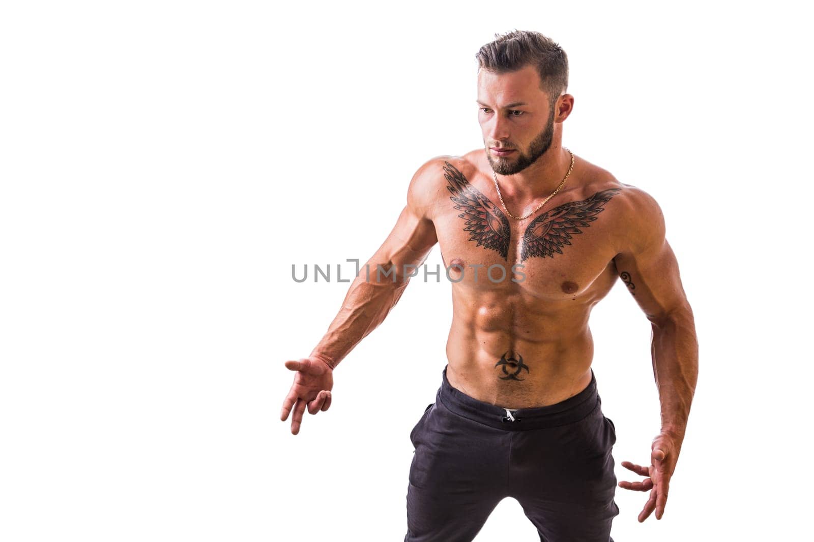 Handsome shirtless muscular man with elegant pants, standing, isolated on white background