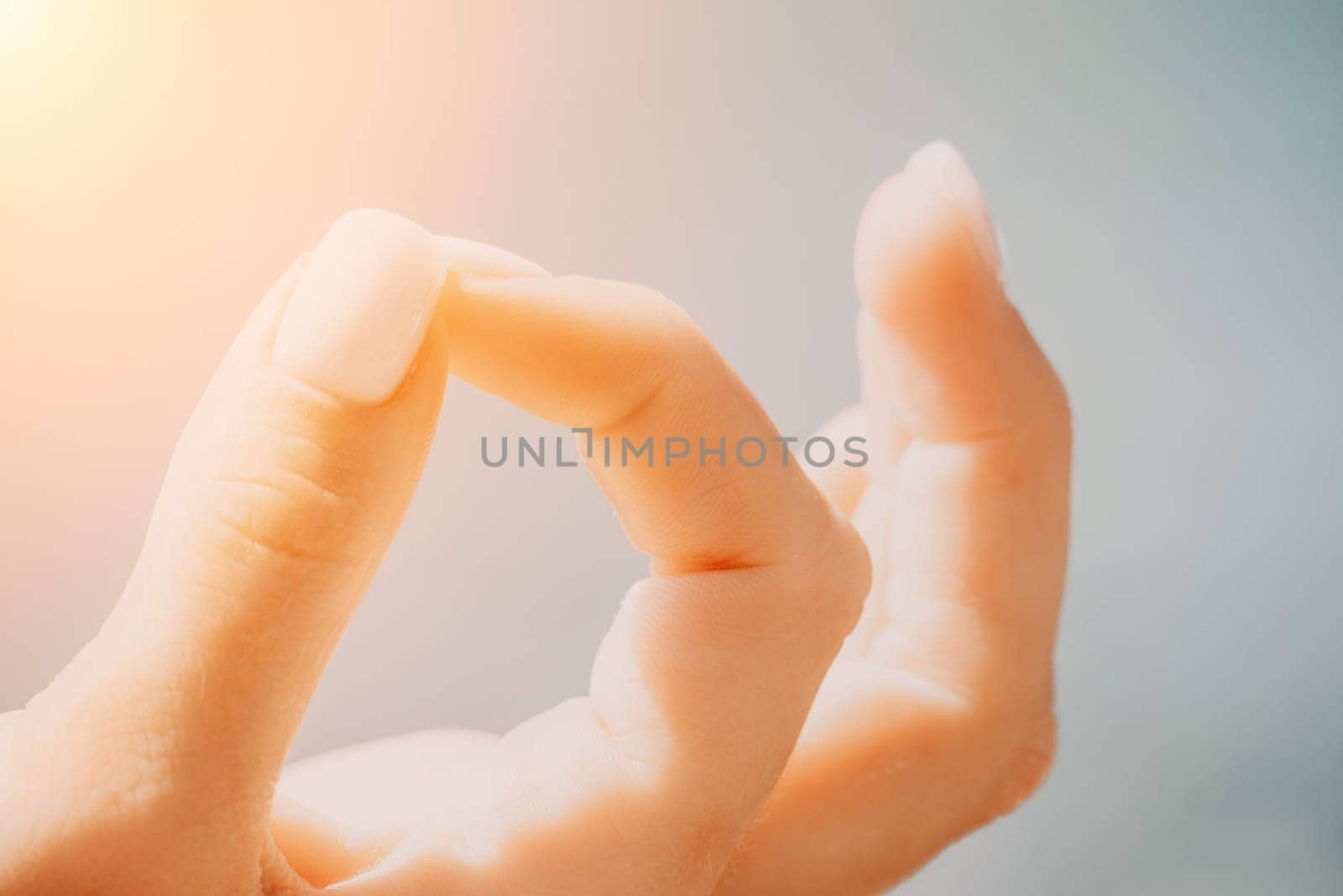 Close up Hand Gesture of Woman Doing an Outdoor Lotus Yoga Position. Close up. Blurred background
