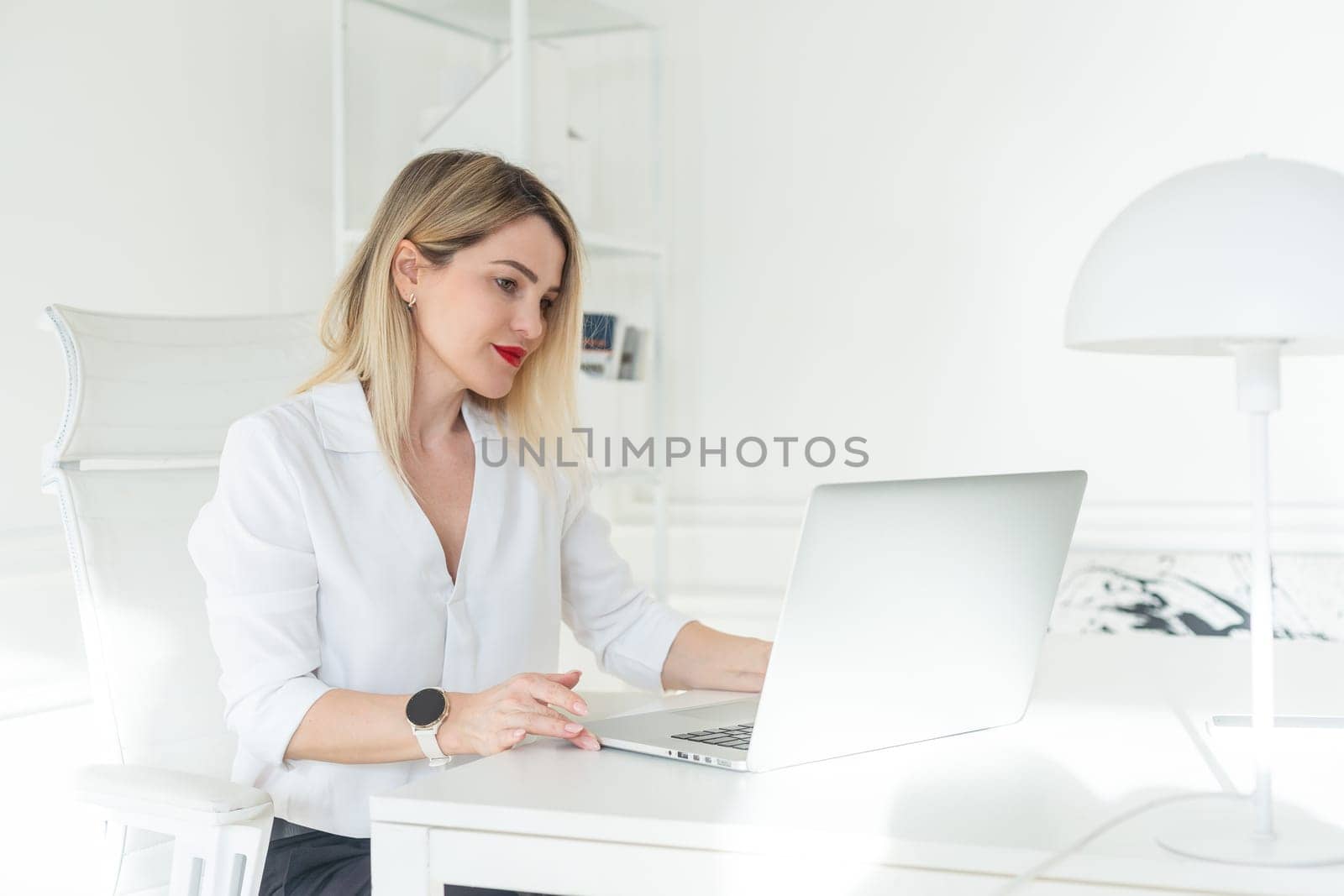 Beautiful business woman at her personal office working on her desk. . High quality photo