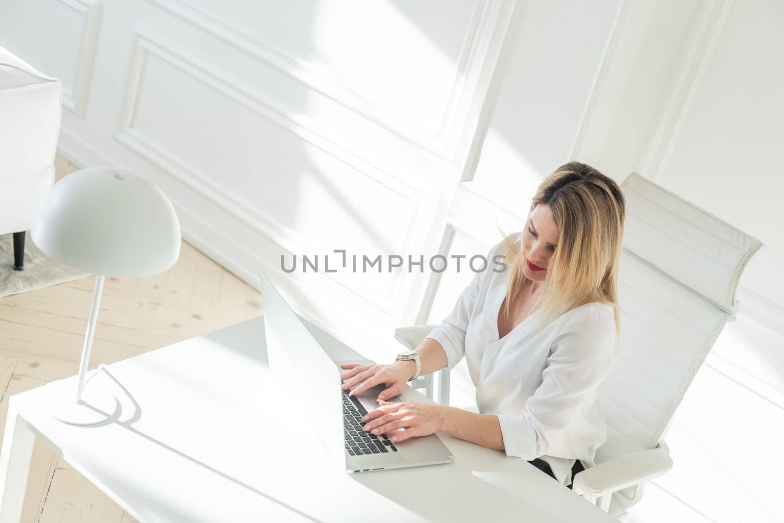 Business woman in office at laptop small business online. High quality photo