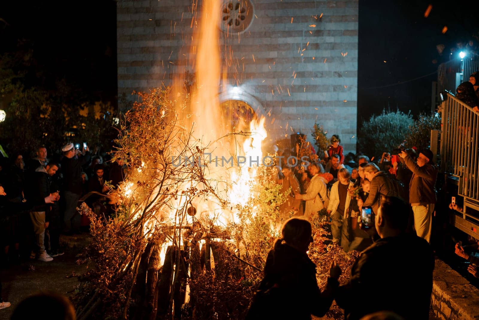 Budva, Montenegro - 06 january 2024: Traditional Oak Branch Bonfire on Christmas Eve in Budva by Nadtochiy