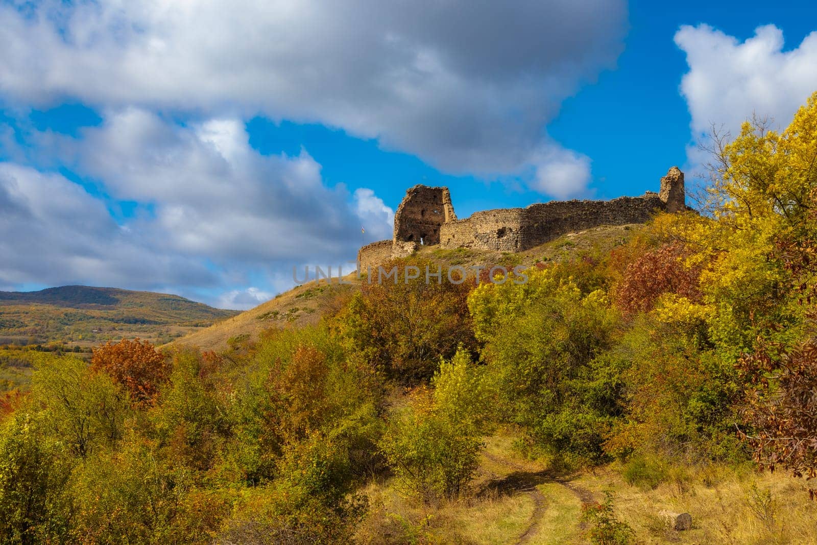 view of a ruined fortress in Ossetia, towering on a hill of a mountain