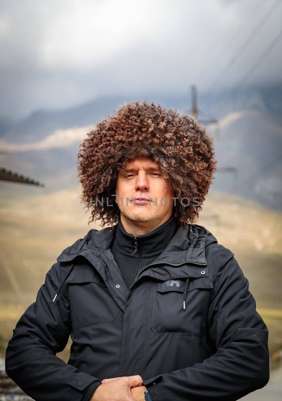 Ossetian man in a national fur hat, expressing pride in his national traditions and culture