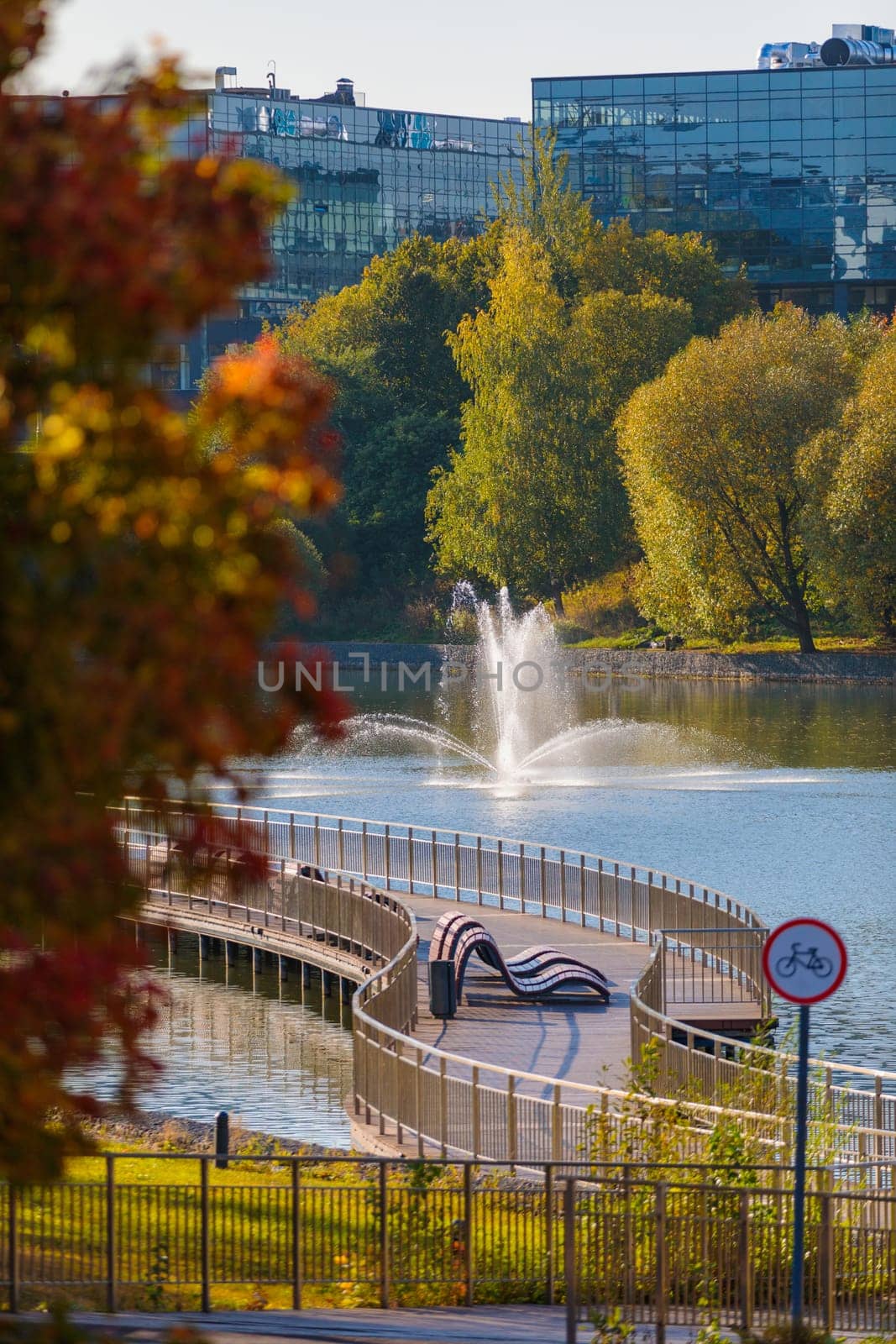 Autumn park with a fountain on a pond in the amazing beauty of nature
