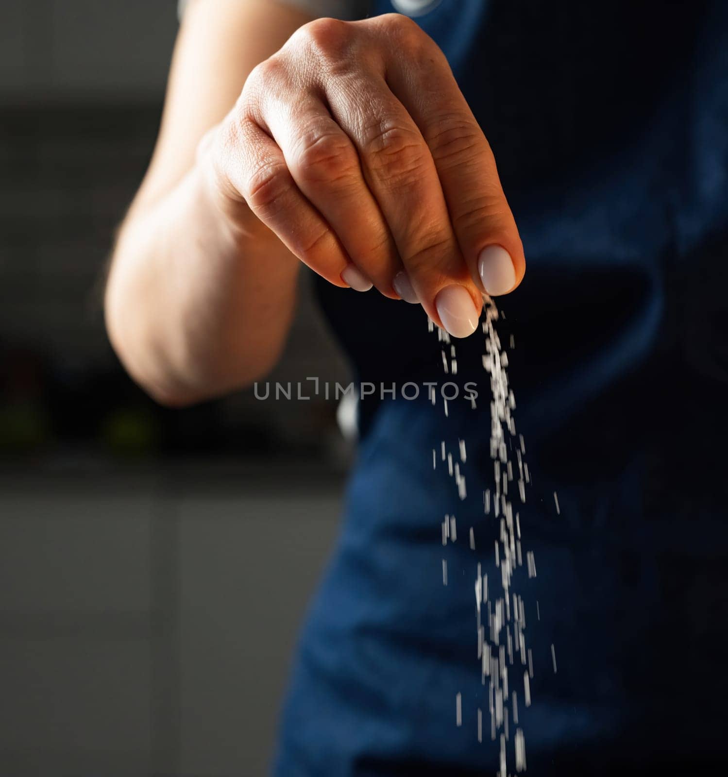 Woman Salts Food With A Pinch Of Salt, Close Up