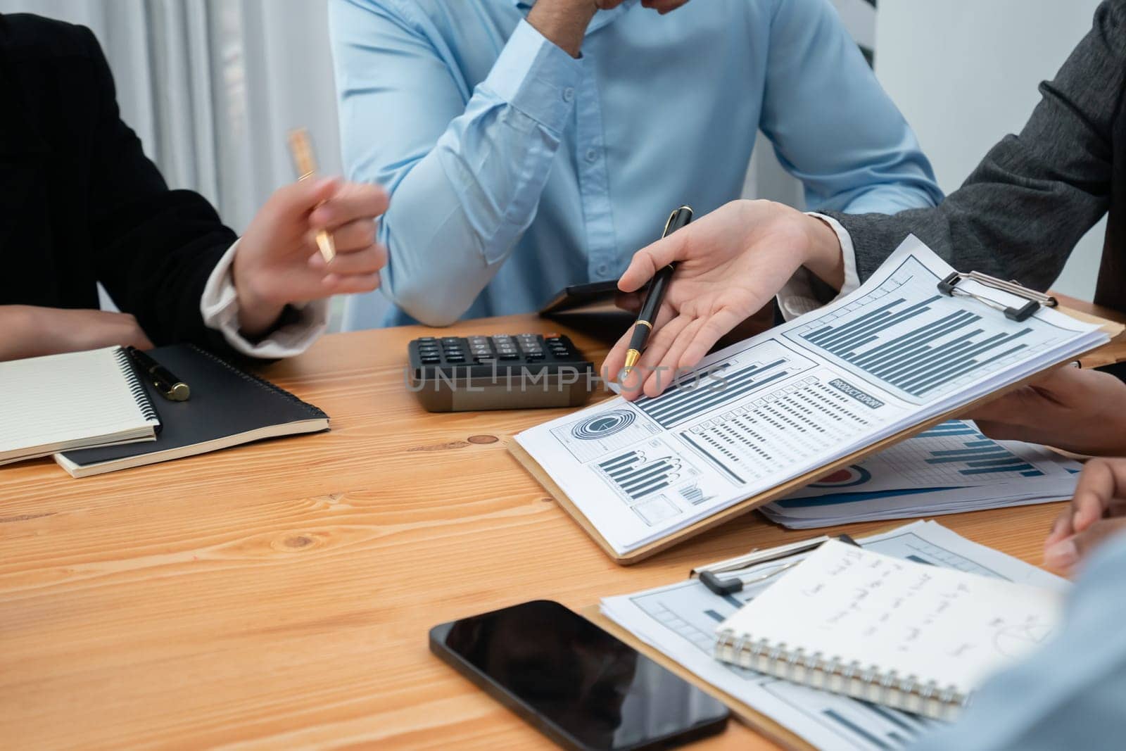 Multiracial analyst team use BI dashboard data to analyze financial report on meeting table. Group of diverse business people utilize data analysis by FIntech for business marketing decision. Concord