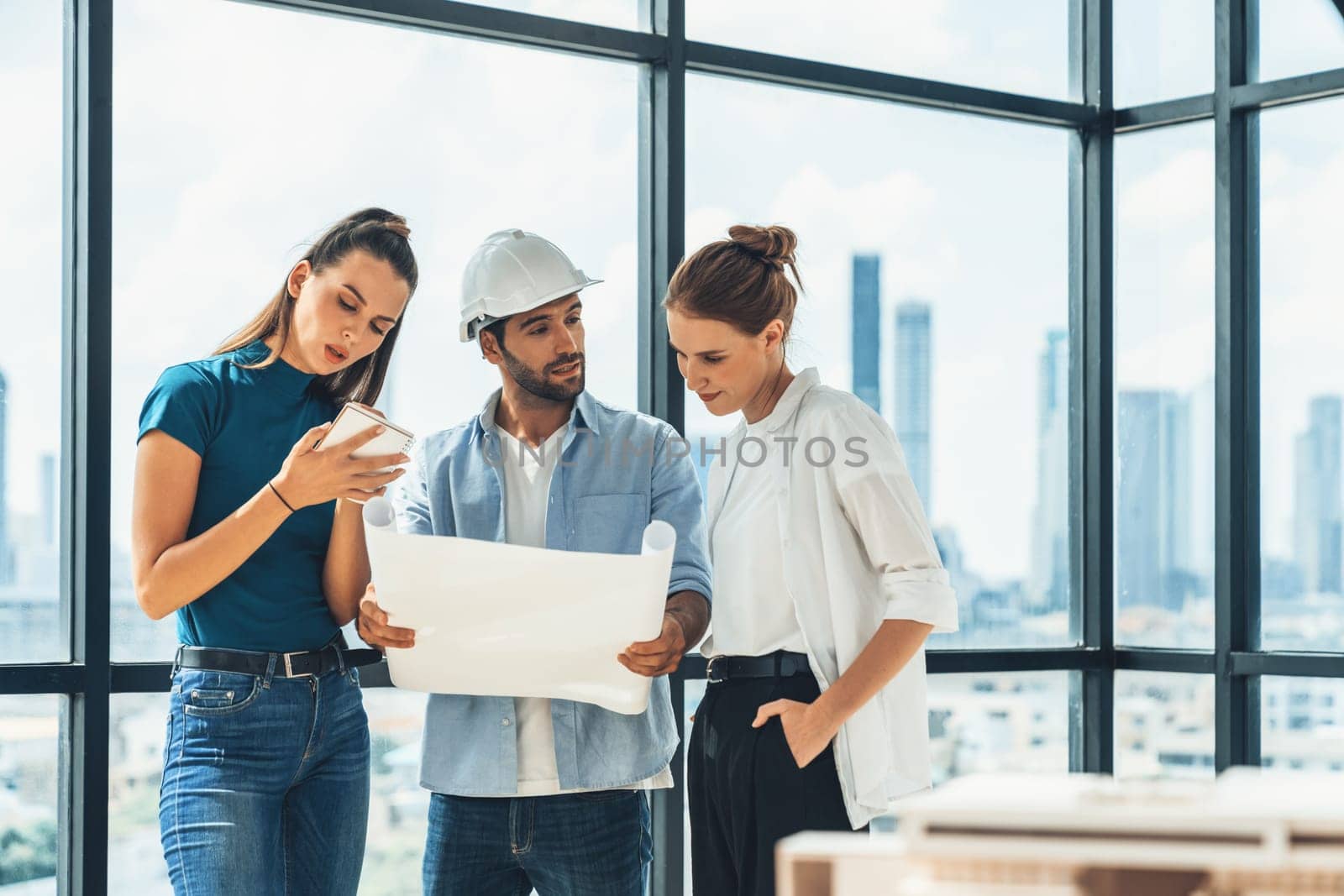 Group of architect engineer looking at project plan while brainstorming idea about building structure. Manager team discuss about building construction while standing near with city view. Tracery.