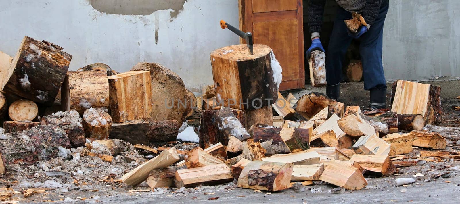 Old ax and a deck for chopping wood. Dry firewood, chopped wood for winter heating of the fireplace.