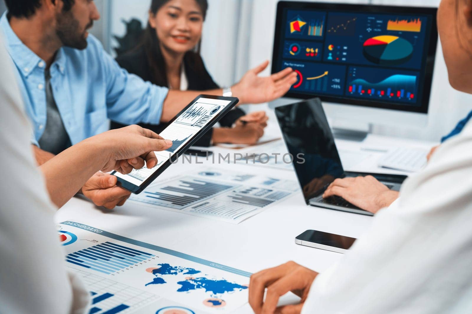 Analyst team uses BI Fintech display tablet to analyze financial data . Business people analyze BI software technology dashboard power for insights power into business marketing planning. Prudent