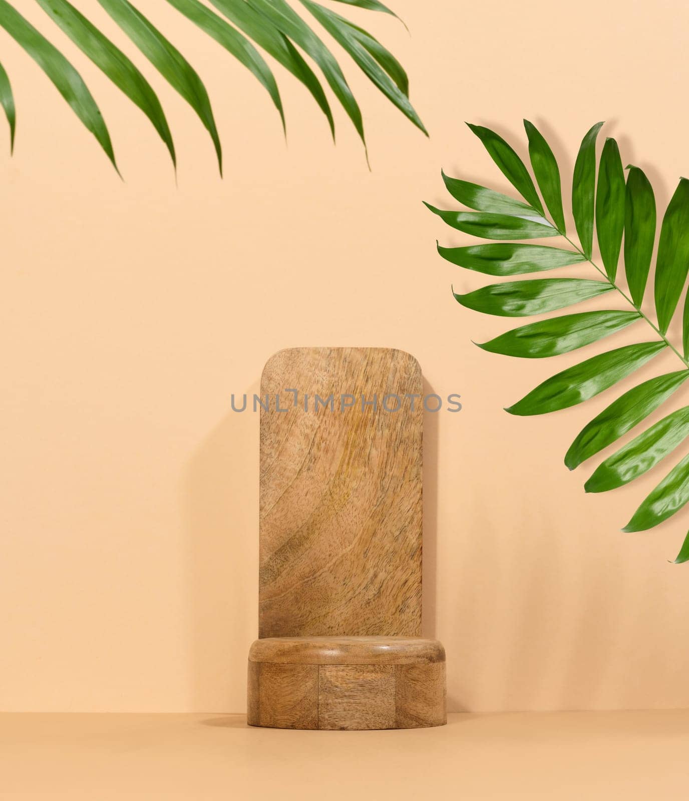 Brown wooden stand on a beige background, a place to display cosmetics and products, copy space