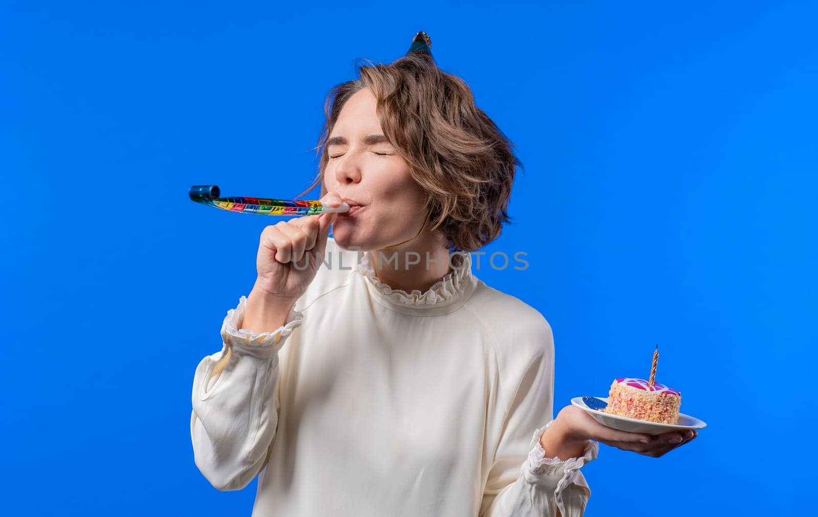 Happy birthday woman making wish - candle on cake. Girl smiling, celebrating. by kristina_kokhanova