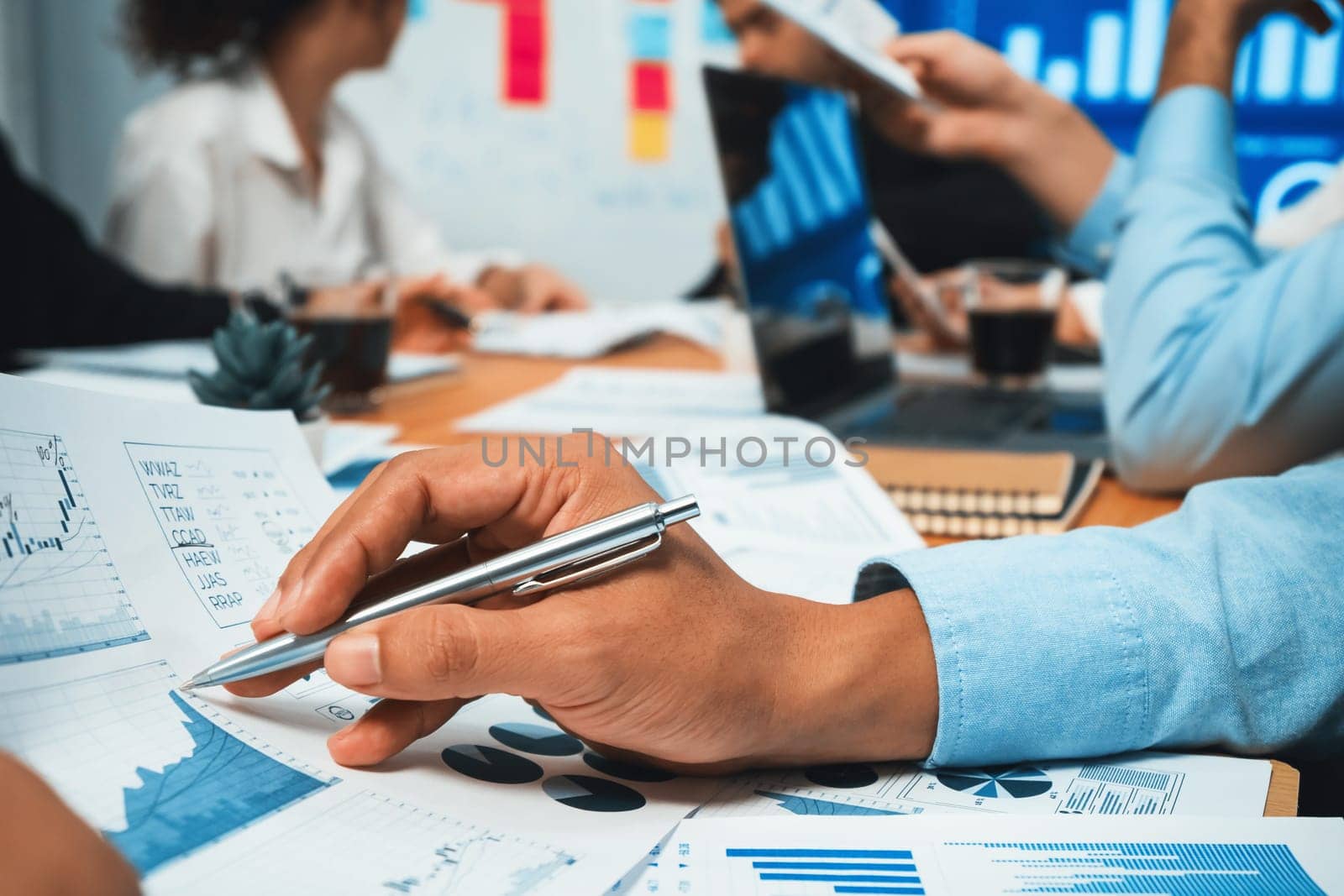 Diverse group of business analyst team analyzing financial data report paper on office table. Chart and graph dashboard by business intelligence analysis for strategic marketing planning Habiliment