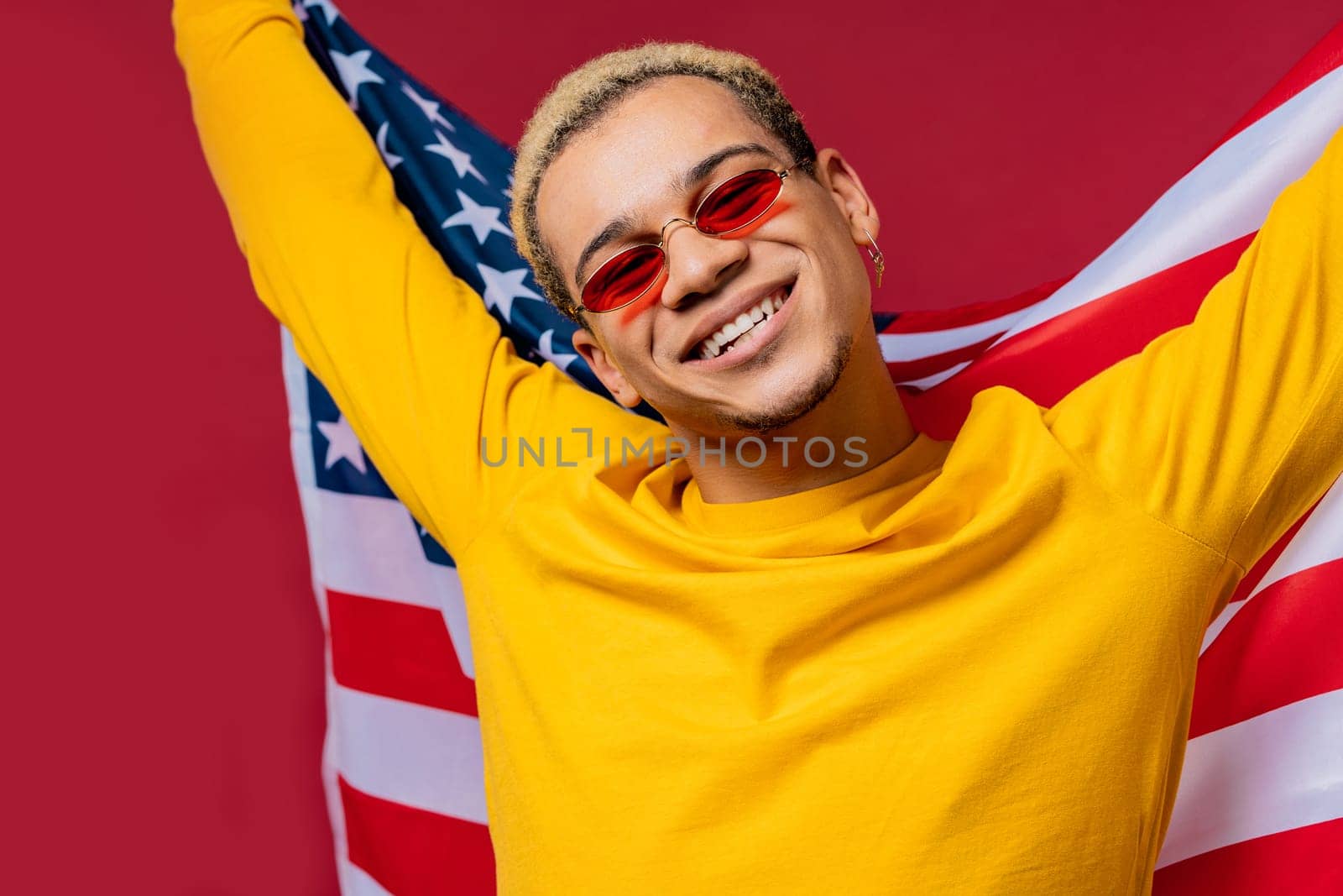Happy man with national USA flag on red background. American patriot 4th of July by kristina_kokhanova