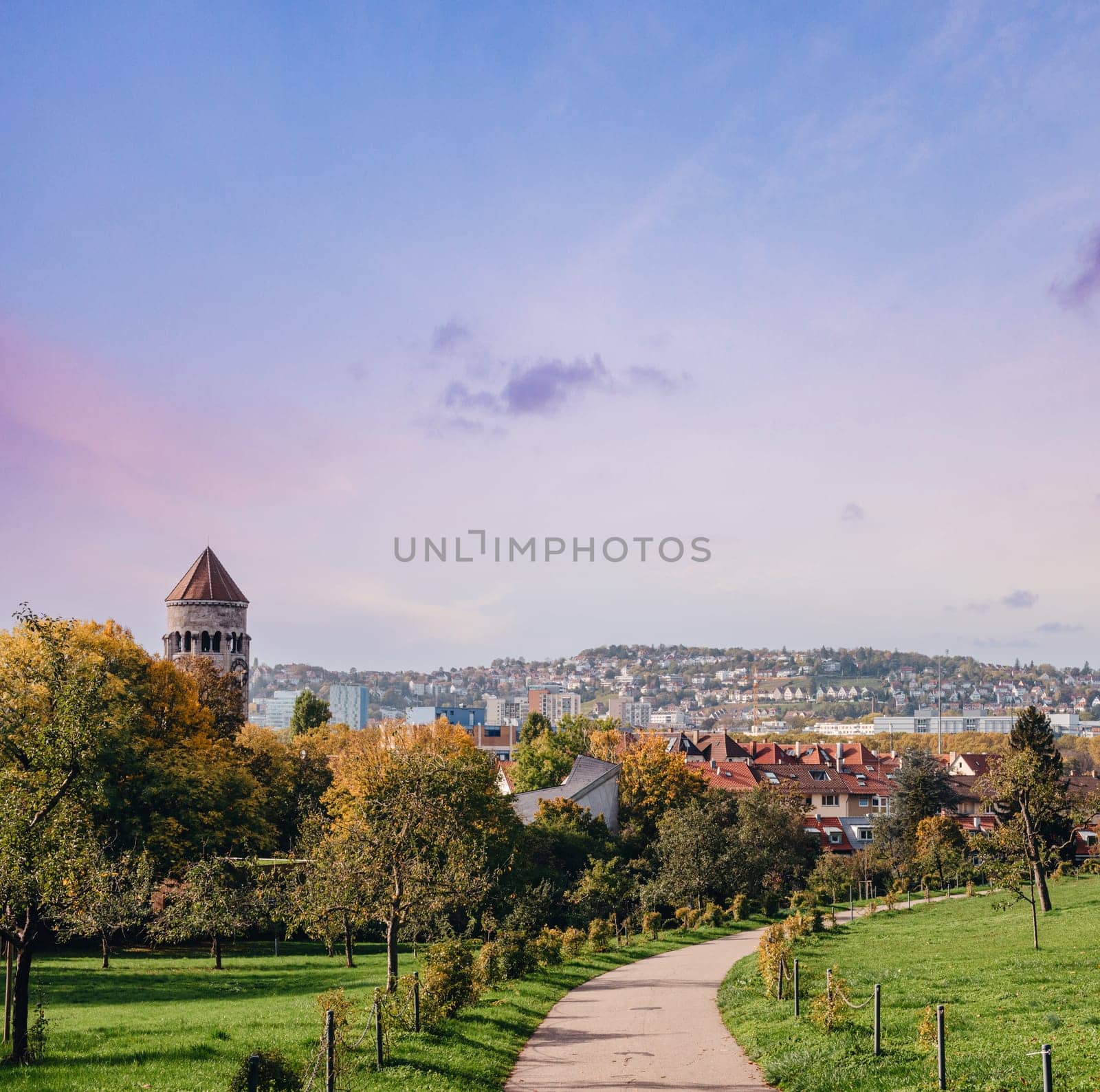 Germany, Stuttgart panorama view. Beautiful houses in autumn, Sky and nature landscape. Vineyards in Stuttgart - colorful wine growing region in the south of Germany with view over Neckar Valley. Germany, Stuttgart city panorama view above vineyards, industry, houses, streets, stadium and highway at sunset in warm orange light by Andrii_Ko