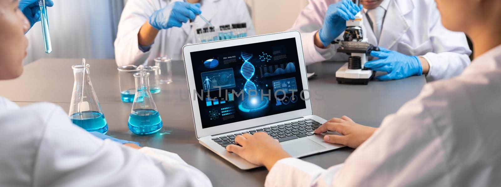 Dedicated scientist group working on advance biotechnology computer software to study or analyze DNA data after making scientific breakthrough from chemical experiment on medical laboratory. Neoteric