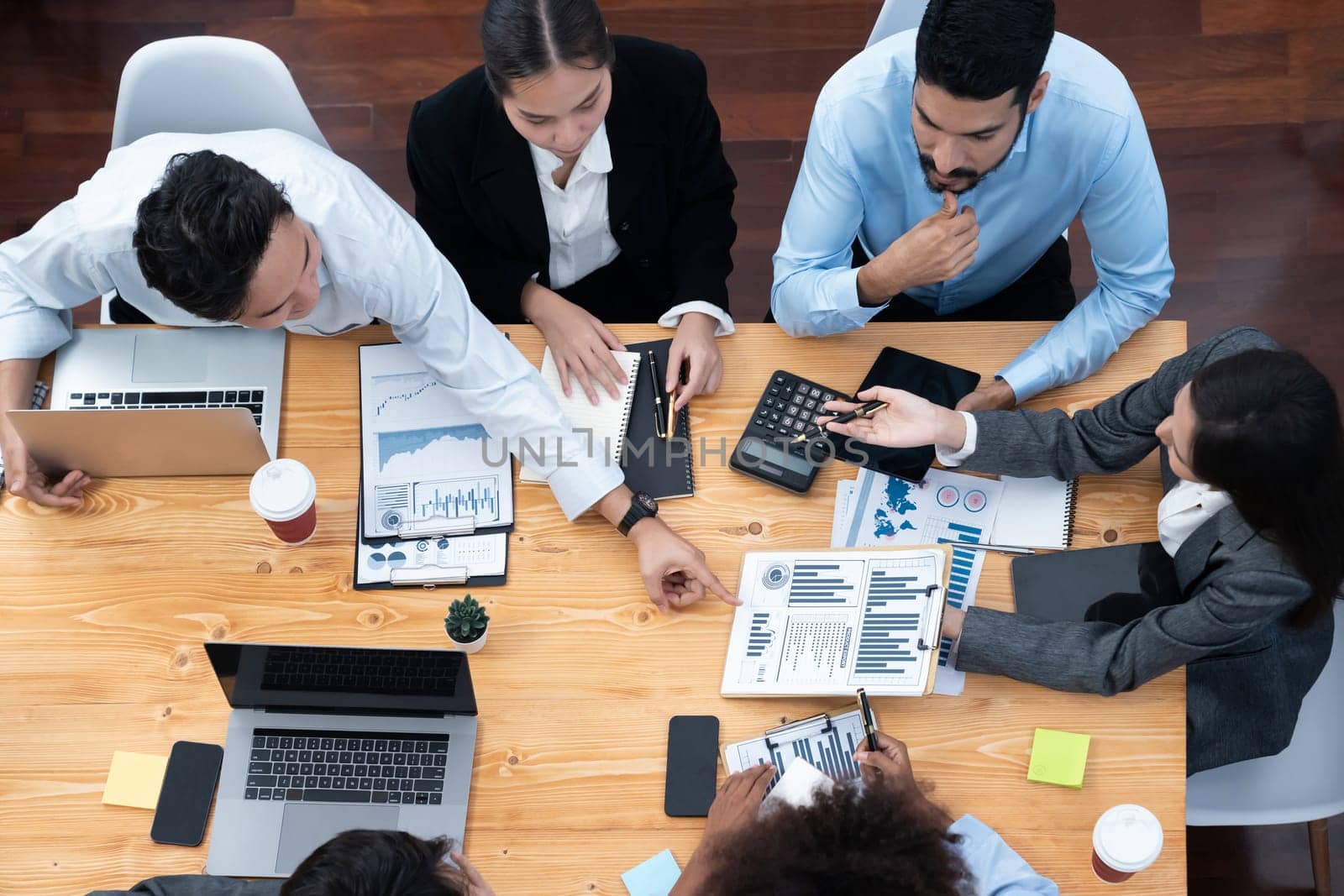 Top view multiracial analyst team use BI dashboard display on laptop screen, analyzing financial data for strategic decision. Fintech analyzes marketing indicators. Concord