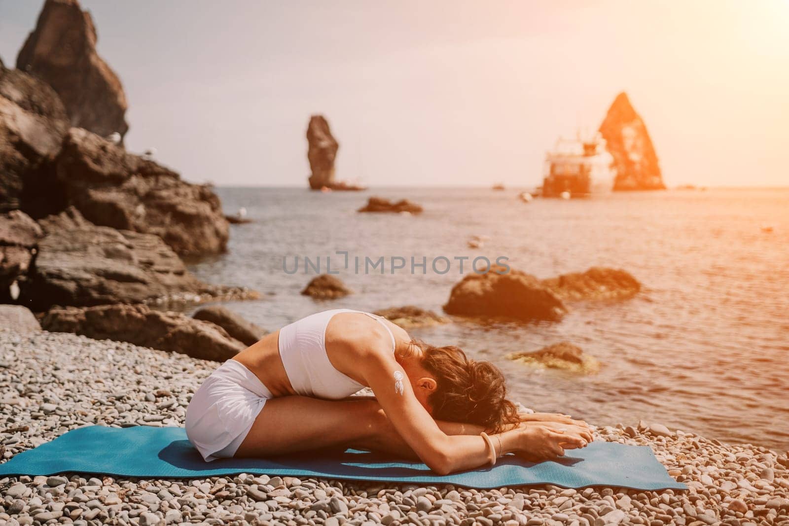 Woman sea yoga. Two Happy women meditating in yoga pose on the beach, ocean and rock mountains. Motivation and inspirational fit and exercising. Healthy lifestyle outdoors in nature, fitness concept. by panophotograph