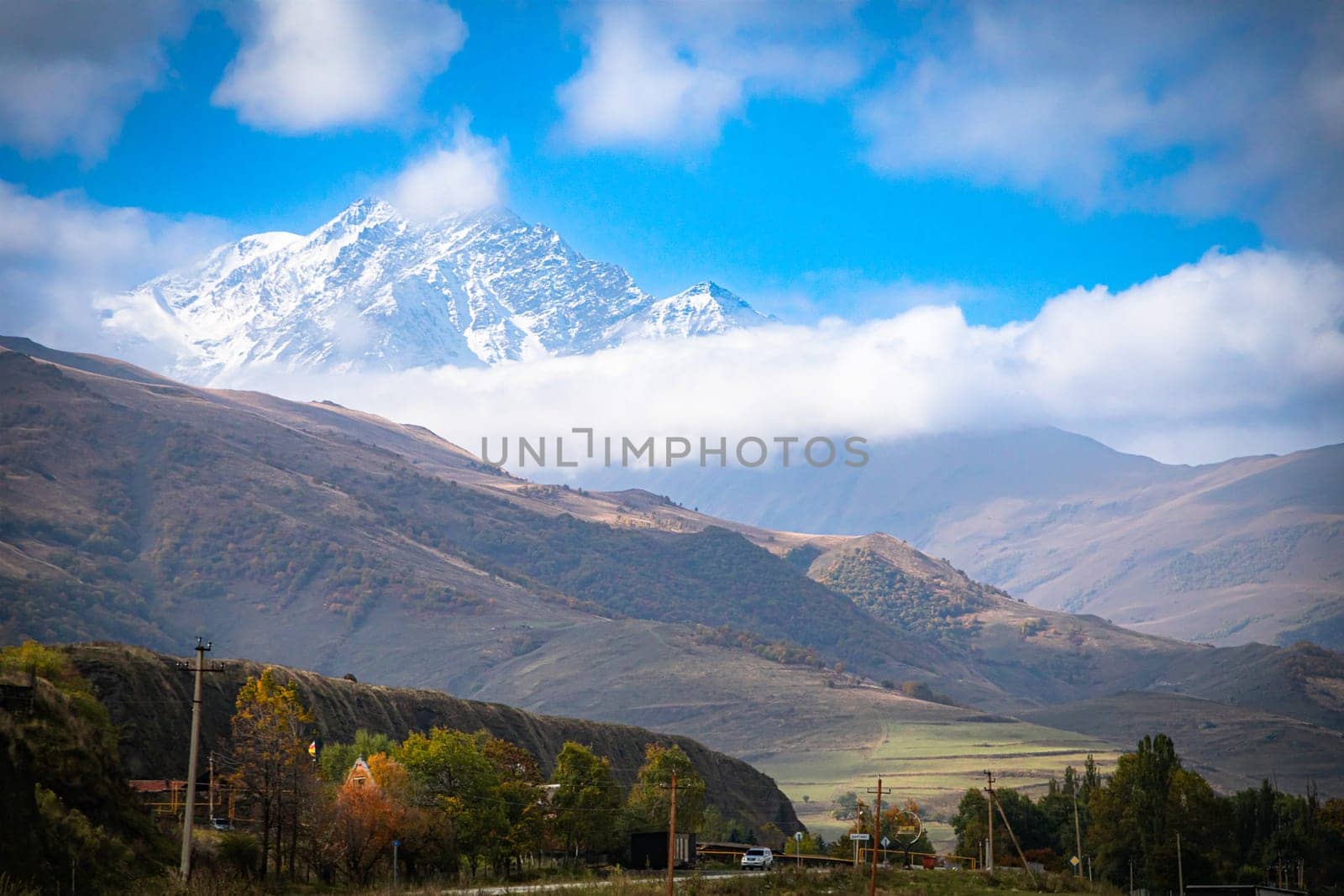 An amazing view of the snow-capped top of the mountain with a beautiful surrounding landscape, embodying the wondrous nature of the northern regions