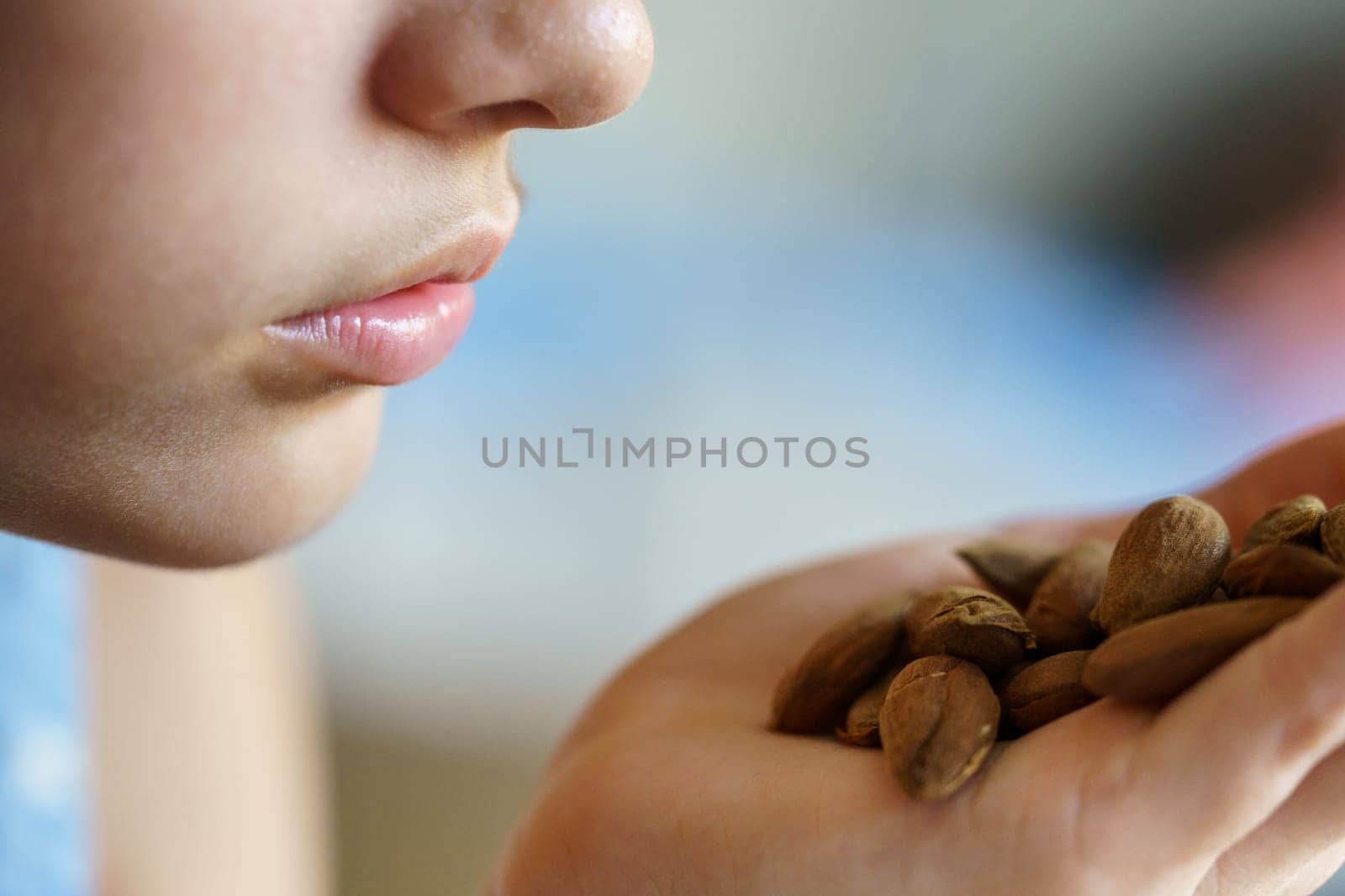 Anonymous girl with fresh almonds in hand by javiindy